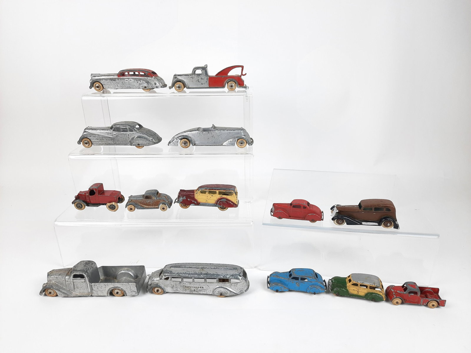 14 Tootsie Toy Cars, Trucks and Buses: 3" to 5-1/2" long. Some paint and wheel losses. LR IMPORTANT: Before bidding, please read the terms and conditions. When you registered for the auction you agreed to these terms and will be required t