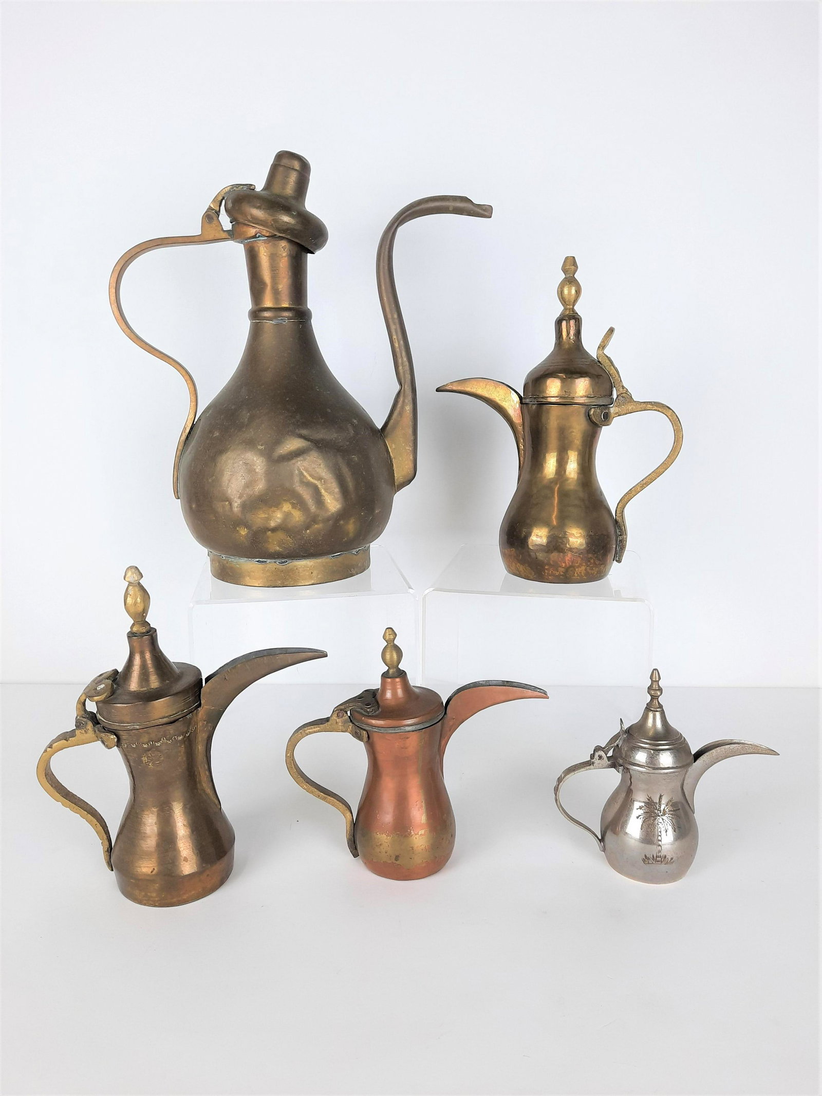 5 Ewers incl Middle Eastern: 5" to 12" high. Largest missing finial from lid. LR IMPORTANT: Before bidding, please read the terms and conditions. When you registered for the auction you agreed to these terms and will be required 