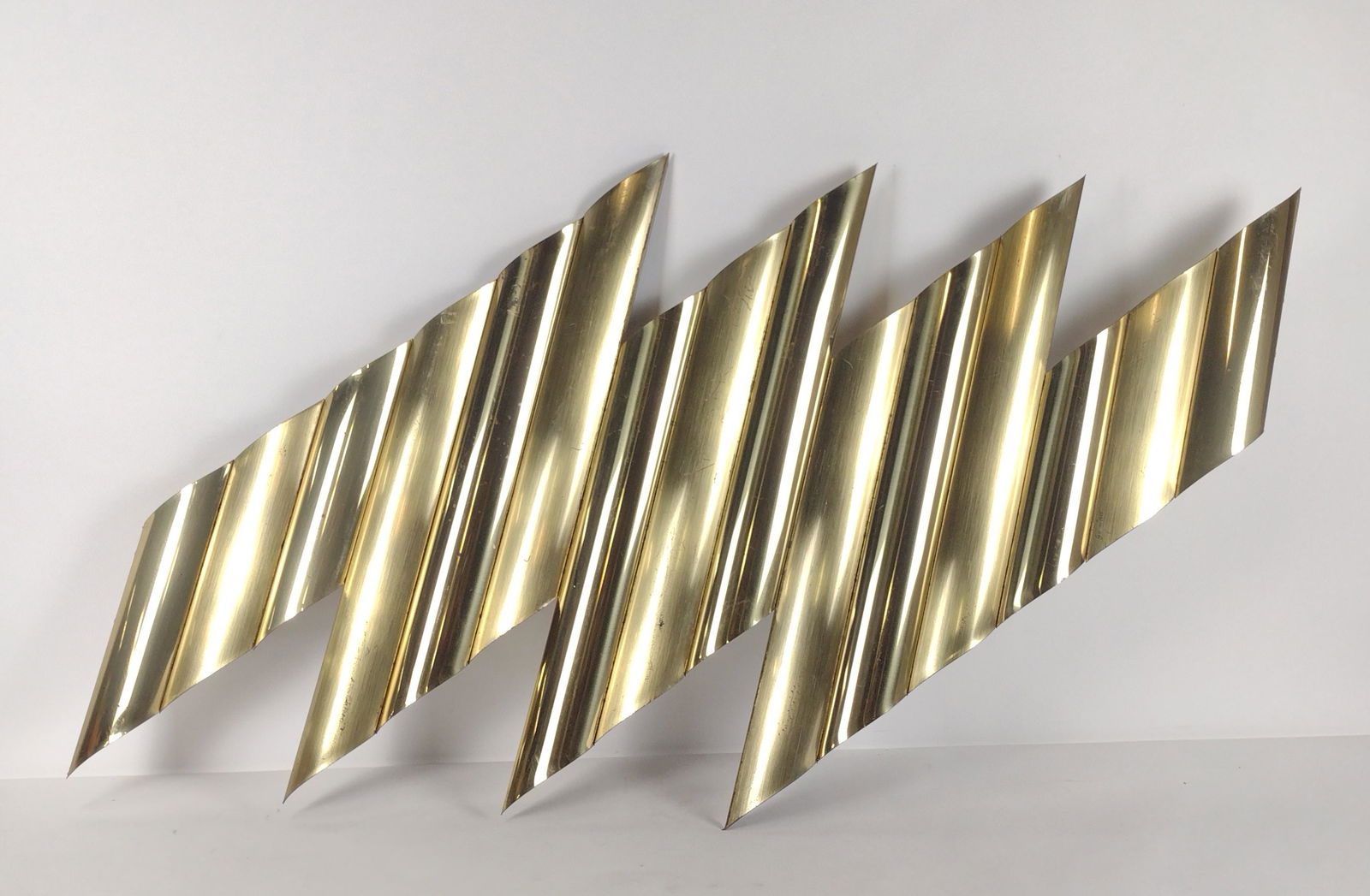 Curtis Jere Brass Geometric Wall Sculpture: 29" high x 47" wide. RM IMPORTANT: Before bidding, please read the terms and conditions. When you registered for the auction you agreed to these terms and will be required to comply with them.