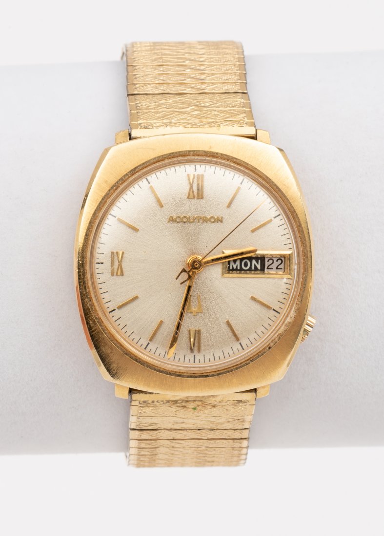 14K Bulova Accutron Wrist Watch: Stamped 14k case model H26142. Speidel stretch band. Running. 1/2" lug to lug. IMPORTANT: Before bidding, please read the terms and conditions. When you registered for the auction you agreed to these 