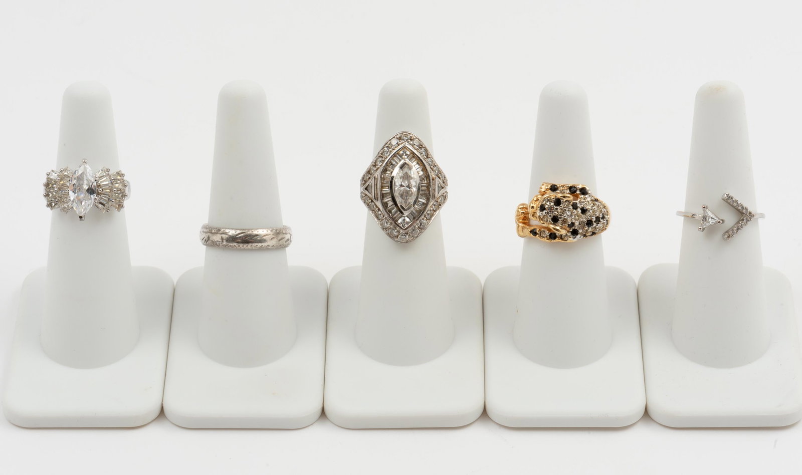 5 Sterling & Fashion Rings: Includes three sterling, one HGE, and one silver. Four with CZ. Sizes 5 to 8. IMPORTANT: Before bidding, please read the terms and conditions. When you registered for the auction you agreed to these t
