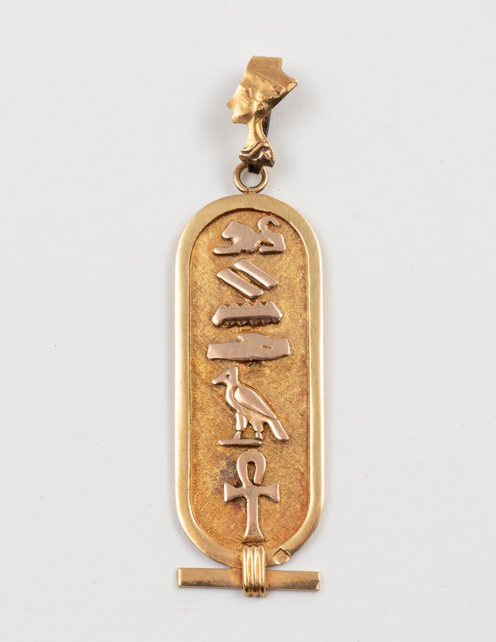 14K Cartouche Pendant: Hallmarked. 2" long. 2.3 dwt. IMPORTANT: Before bidding, please read the terms and conditions. When you registered for the auction you agreed to these terms and will be required to comply with them.
