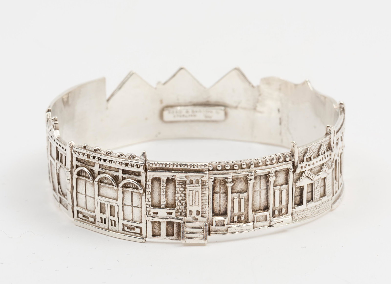 Reed & Barton Signature V Sterling Bangle: Reed & Barton Signature V Collection Linda Watson bangle bracelet depicting buildings. 1977. Stamped Reed & Barton Sterling. 2-3/8" interior diameter. 7/8" wide. 1.4 ozt. IMPORTANT: Before bidding, pl