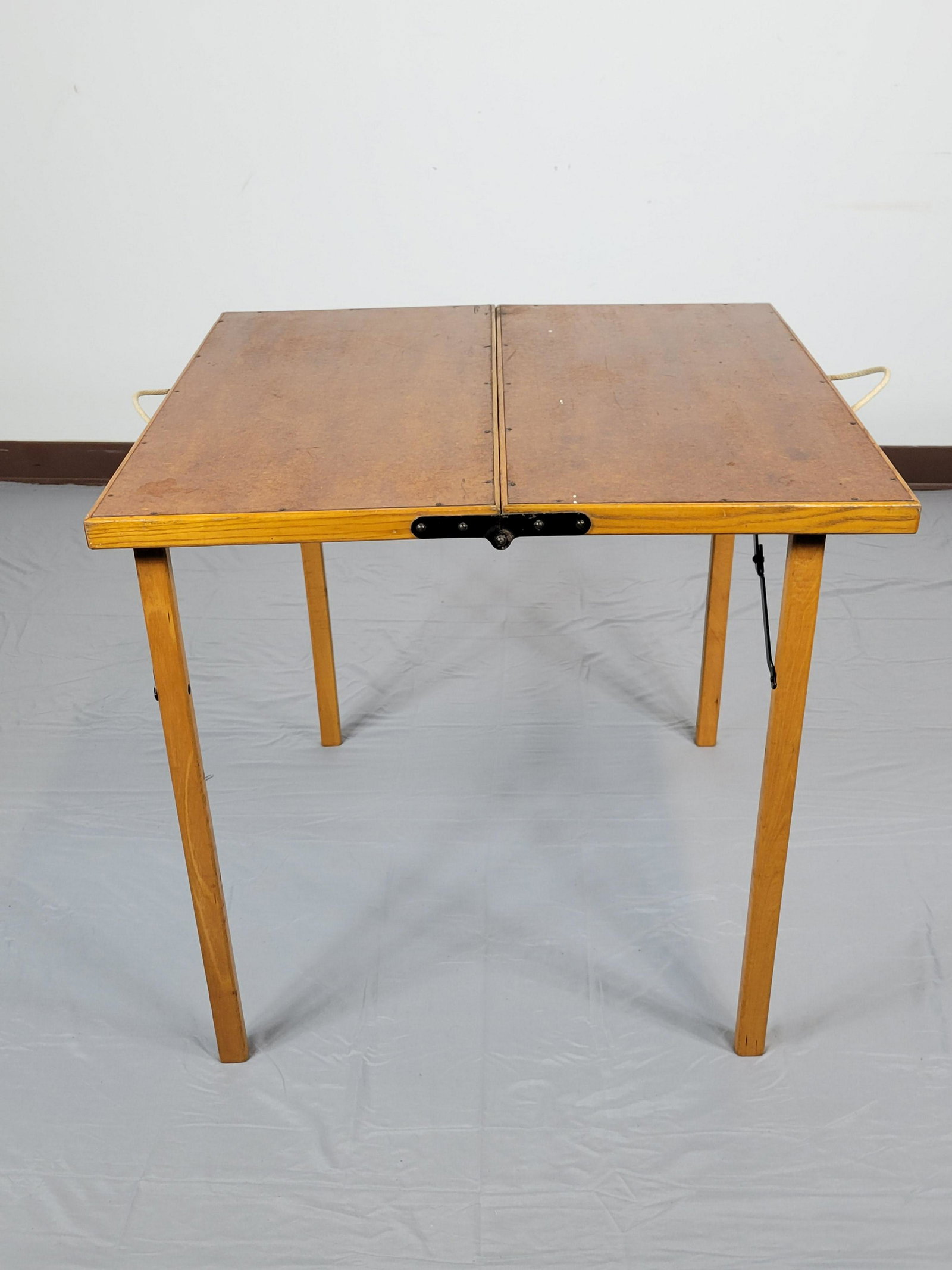 Folding Card Table: 30" wide X 30" deep X 27" high. Top has discoloring. Side hinges have some paint loss. MG. IMPORTANT: Before bidding, please read the terms and conditions. When you registered for the auction you agre