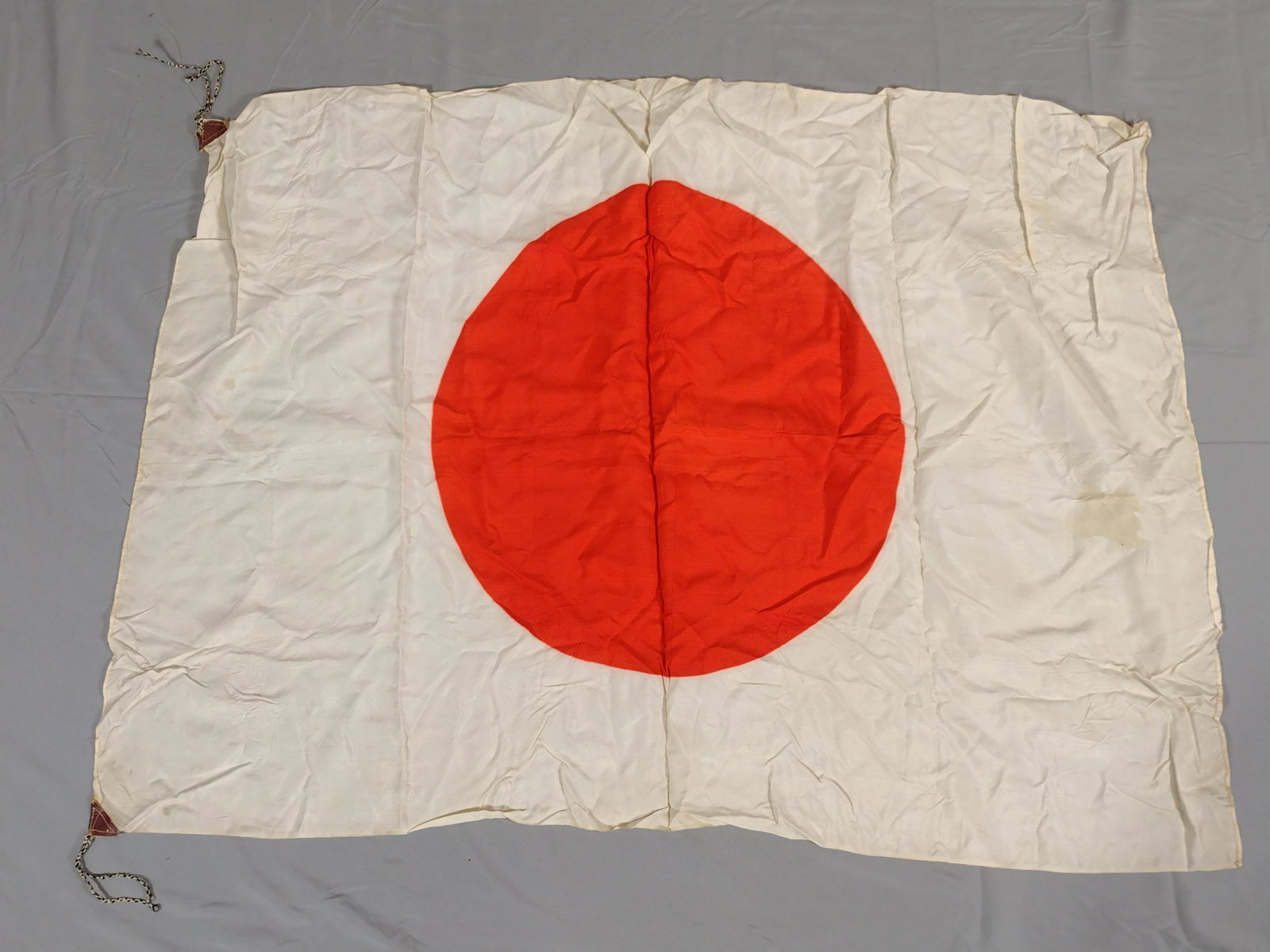 WWII Japanese Flag: 37" wide X 26" high. Some discoloration. LR IMPORTANT: Before bidding, please read the terms and conditions. When you registered for the auction you agreed to these terms and will be required to compl