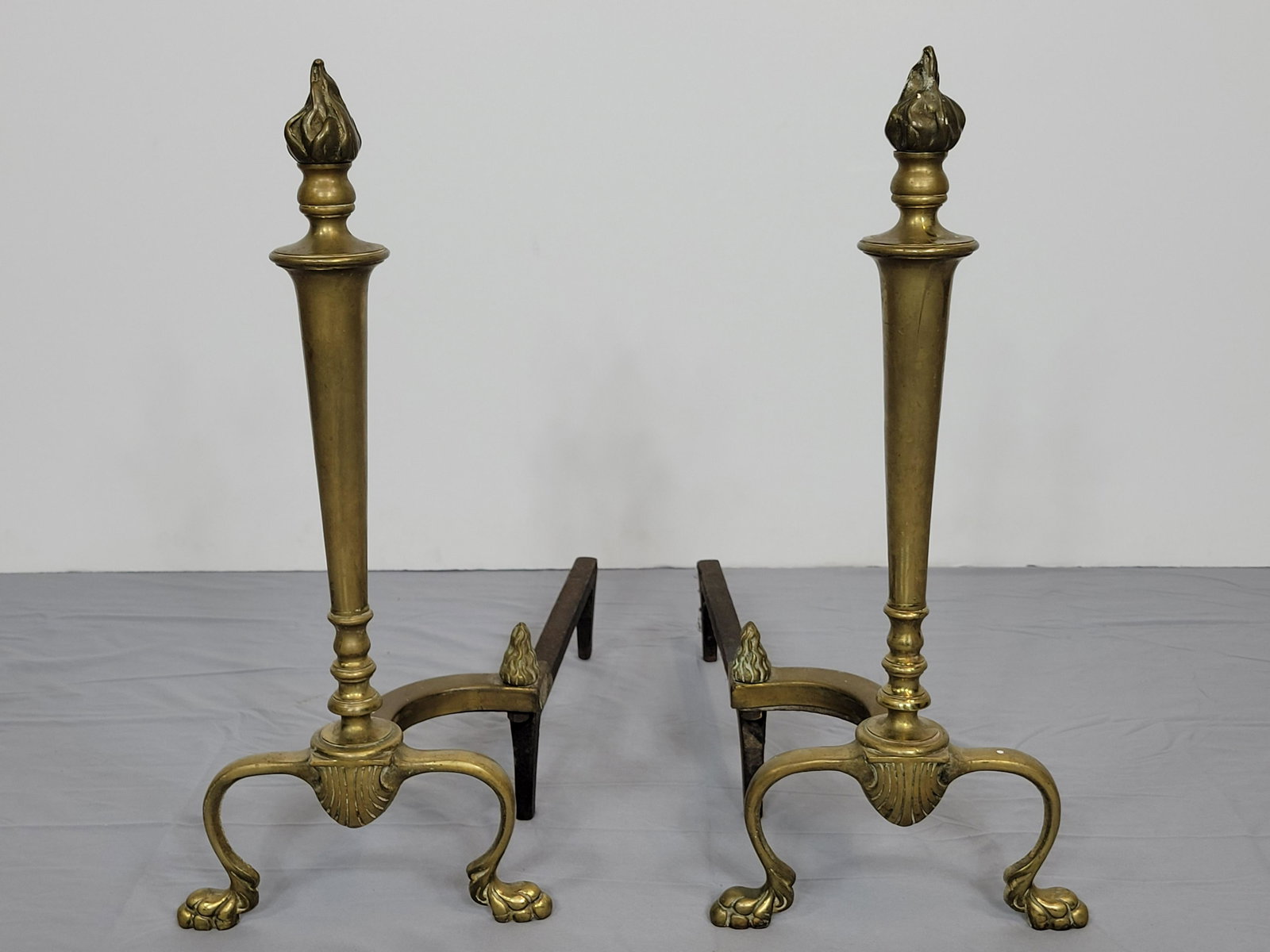 Pair Of Brass Andirons: 8 1/2" wide X 17 1/2" deep X 20" high. MG. IMPORTANT: Before bidding, please read the terms and conditions. When you registered for the auction you agreed to these terms and will be required to comply