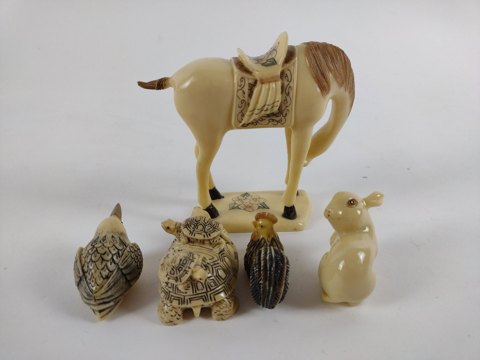 5 Resin Animals incl Netsukes and Tang Style Horse: Rabbit missing ear. 2" to 4 1/2" wide x 1 1/4" to 4 1/4" high. JK IMPORTANT: Before bidding, please read the terms and conditions. When you registered for the auction you agreed to these terms and wil