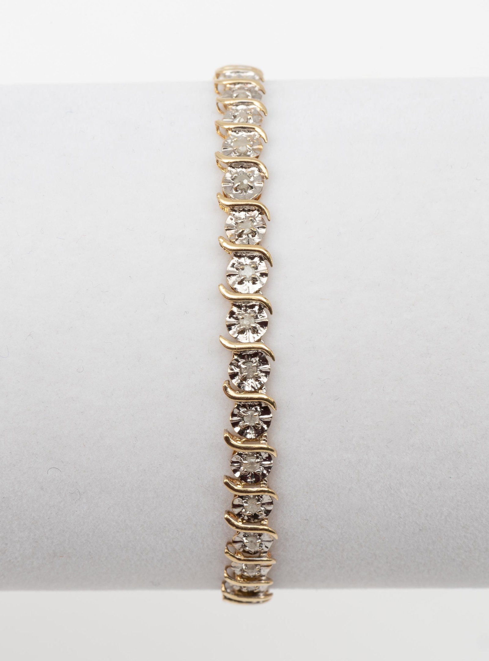 10K Gold and Diamond Bracelet: 10k yellow gold and 34 appx 1 pt diamonds. 7-1/2" long. 3.7 dwt. MH. IMPORTANT: Before bidding, please read the terms and conditions. When you registered for the auction you agreed to these terms and 