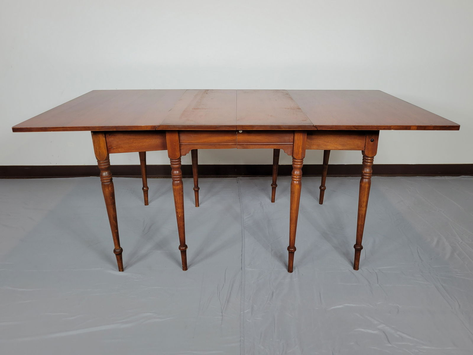 Gate Leg Drop Leaf Table: Open 72", closed 26" wide X 40" deep X 30" high. Has chips in veneer on drop Leaf. MG. IMPORTANT: Before bidding, please read the terms and conditions. When you registered for the auction you agreed t