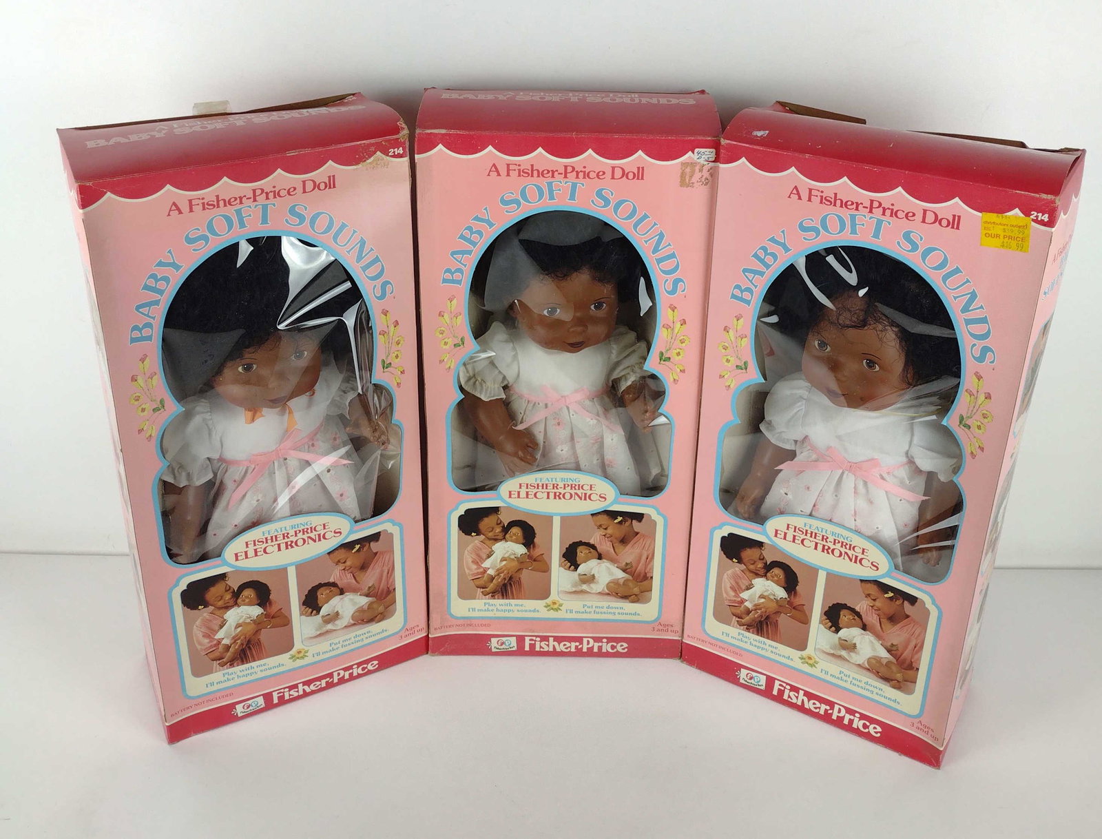 3 Baby Soft Sounds Dolls: Manufactured by Fisher-Price Toys, 1980. Style number 214. Includes original boxes. Boxes 20-1/4" high x 9-1/2" wide. Slight wear to boxes. Sold as is. DP. IMPORTANT: Before bidding, please read the t