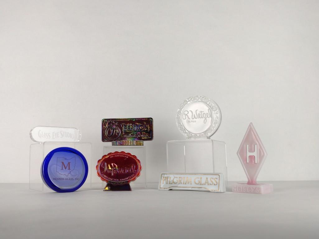 7 Glassware Dealer Display Signs: Includes R. Wetzel Glass, Imperial, Mosser Glass Inc., Fenton, Glass Eye Studio, Pilgrim Glass and Heisey's. Fenton sign labeled to back and has original tag. Heisey's sign marked June 17, 1992. 1-1/4