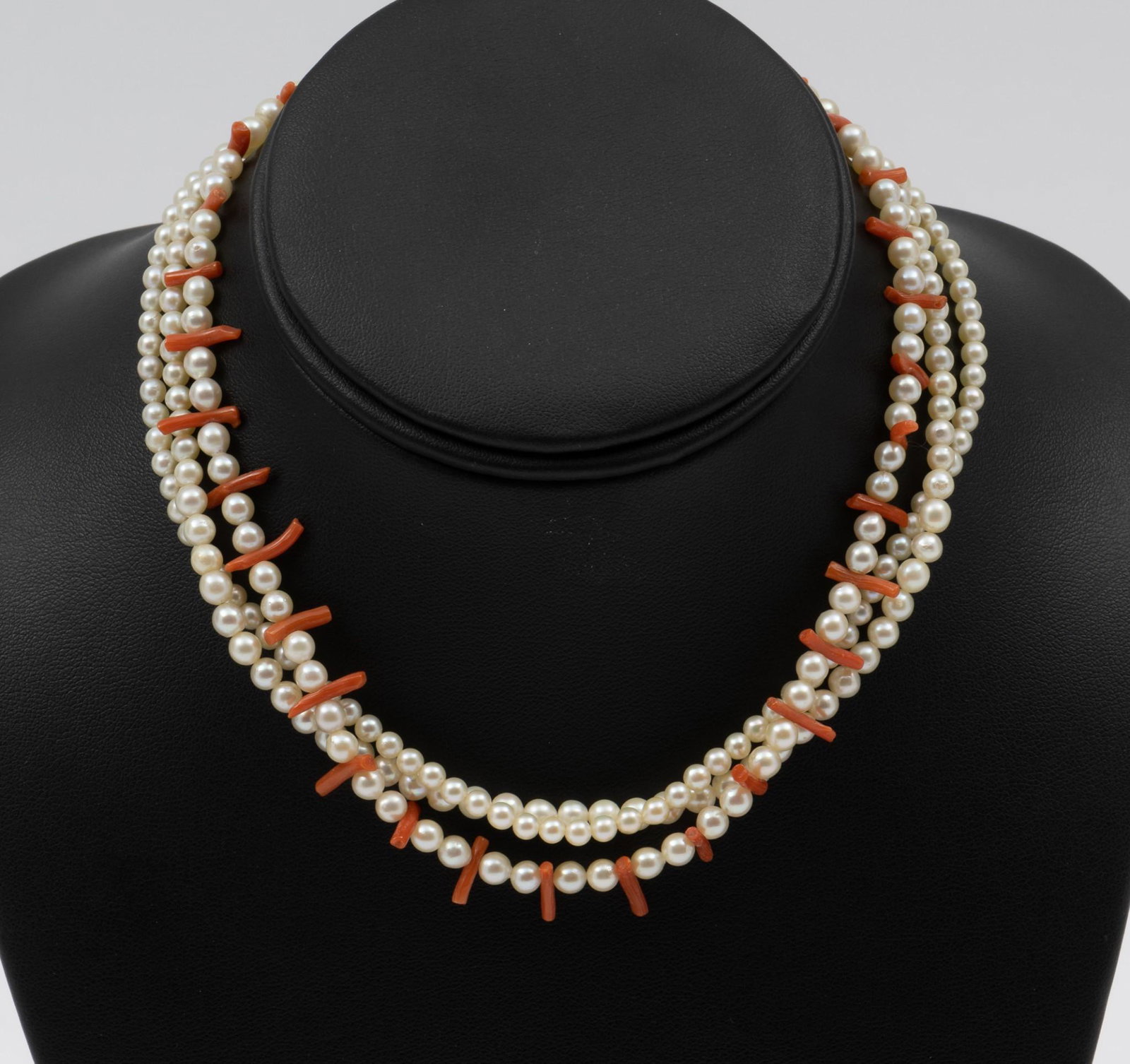 Pearl & Coral Triple Strand Necklace: 14K clasp. 3-1/2 to 5-1/2 mm beads with 1/4" long coral accents. 14-1/2" long. KE. IMPORTANT: Before bidding, please read the terms and conditions. When you registered for the auction you agreed to th