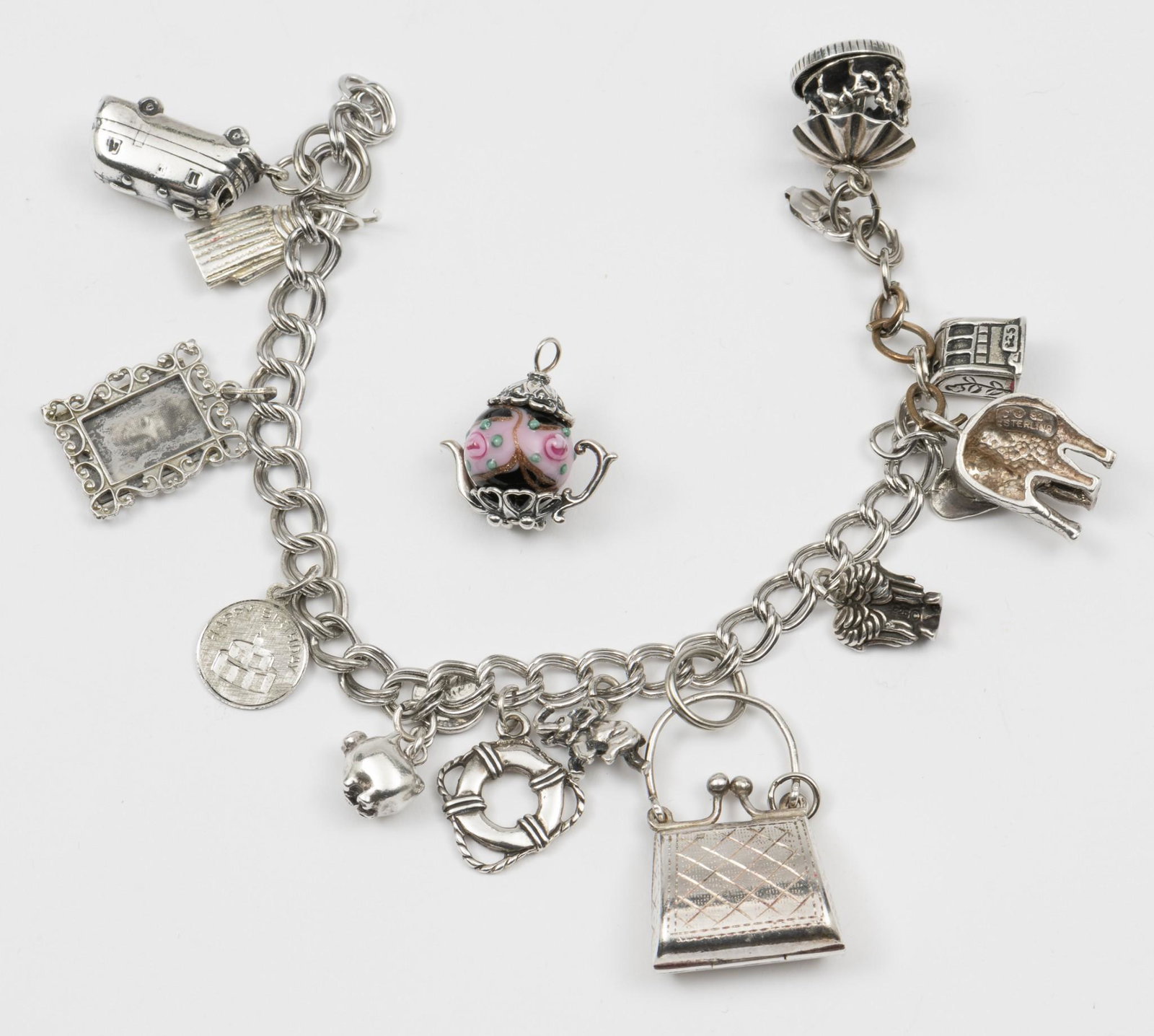 Sterling Charm Bracelet: Charms 1/2" to 1-1/2" long. Bracelet 7" long. MH. IMPORTANT: Before bidding, please read the terms and conditions. When you registered for the auction you agreed to these terms and will be required to