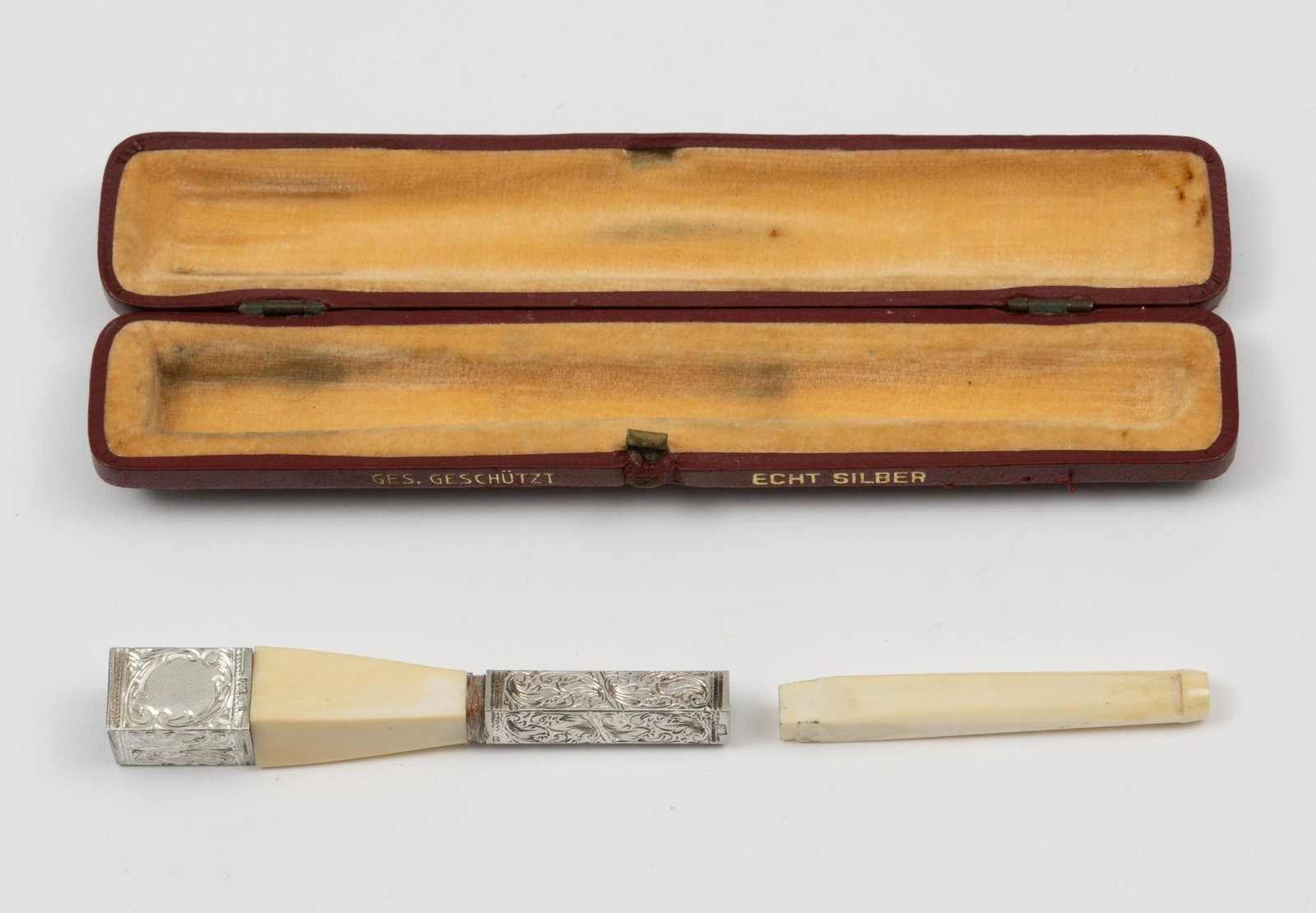 Antique Sterling Mounted Bone Cigarette Holder: German silver. In original case marked Ges. Geschutzt Echt Silber (Protected by Law Real Silver). Indecipherable makers mark. 5" long. KE. IMPORTANT: Before bidding, please read the terms and conditio