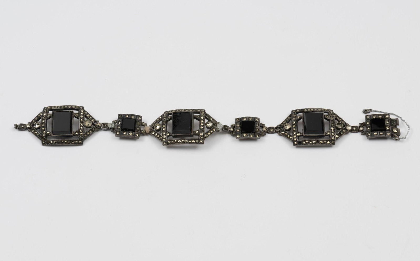 Antique Sterling, Onyx, & Marcasite Bracelet: Repaired at three links. 7-1/2" long x 3/4" wide. Does not have working clasp. DP/MH. IMPORTANT: Before bidding, please read the terms and conditions. When you registered for the auction you agreed to