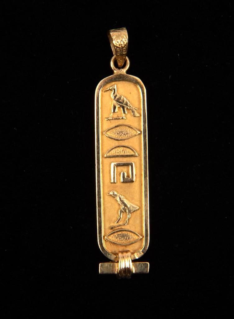 18K Cartouche Pendant: 1-7/8" long. 2.5 dwt. MH. IMPORTANT: Before bidding, please read the terms and conditions. When you registered for the auction you agreed to these terms and will be required to comply with them.