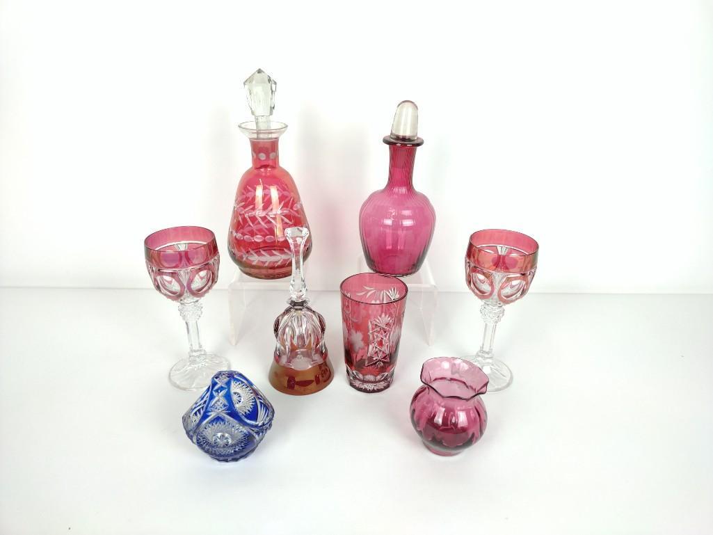 8 Pcs Cranberry Glass Incl Cut to Clear: Decanters 9" high to 10-1/2" high, wine glasses 7-1/2" high, bell 8-1/4" high. RM. IMPORTANT: Before bidding, please read the terms and conditions. When you registered for the auction you agreed to th