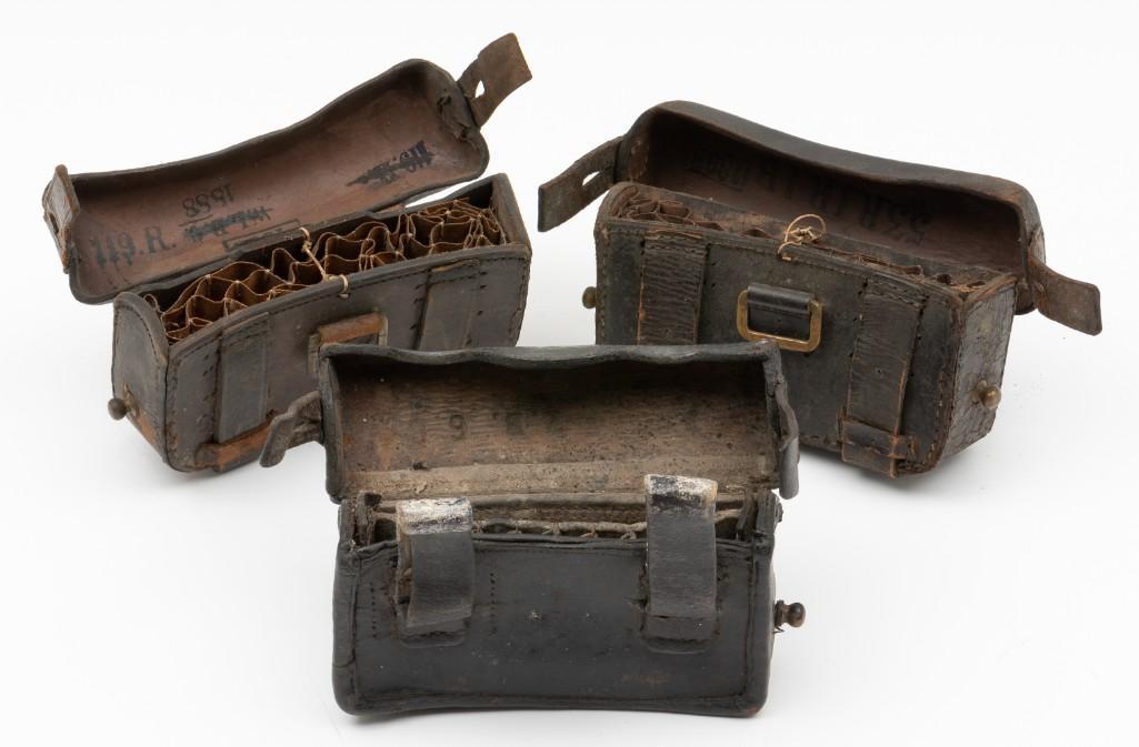 Three Pre WWI Imperial German Ammo Pouches: Three ammo pouches from late 1800s. Two 1871/84 Mauser rifle pouches with marked to underside of lids. One 1874/87 pouch. 6-1/2" wide x 3-1/2" high x 1-3/4" deep. Missing one rivet clasp. Wear commens