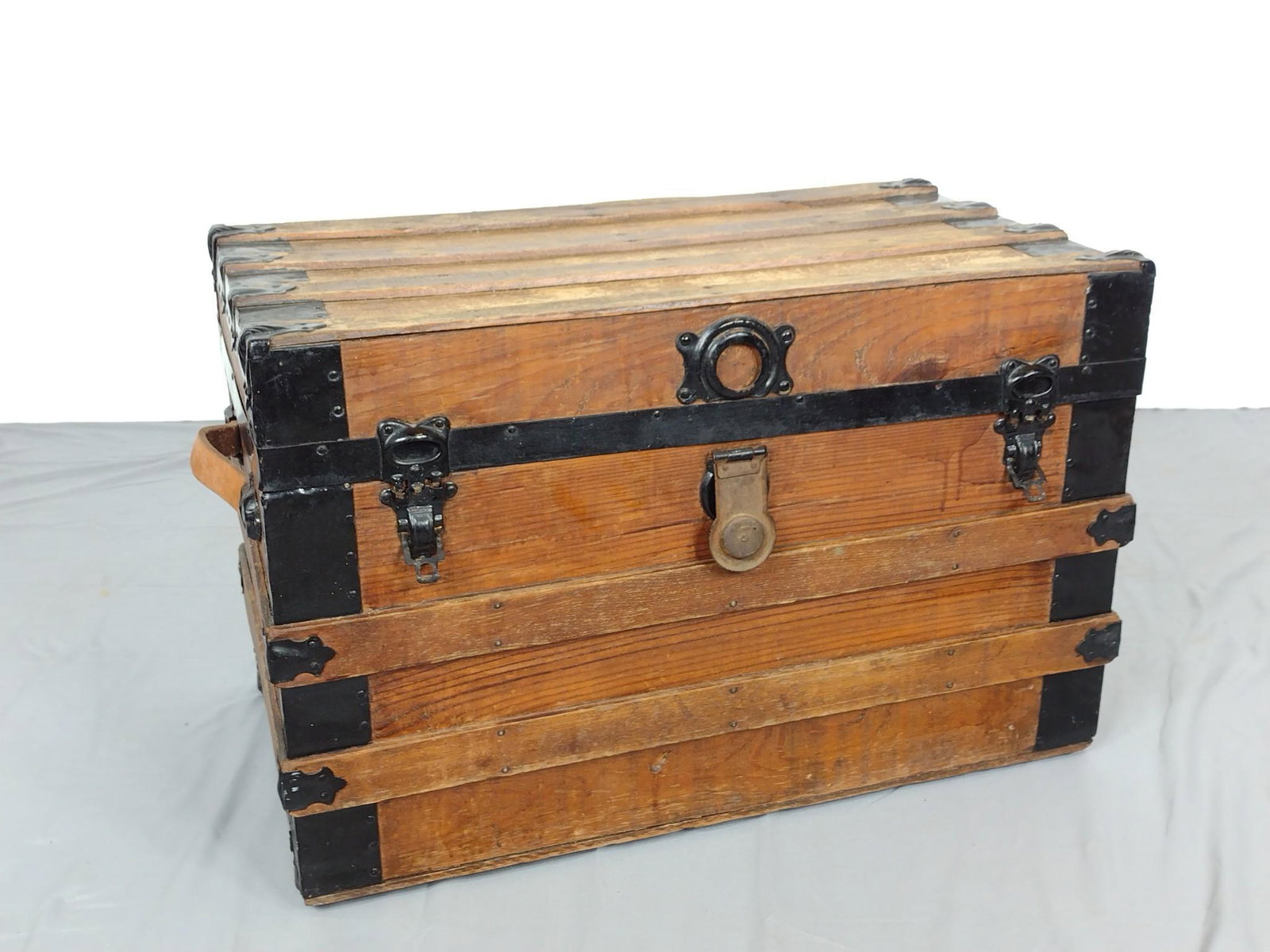 Steamer Trunk: Paper lined. 28 1/2" wide X 16" deep X 18 1/2' high. Has scratches and finish loss. MG. IMPORTANT: Before bidding, please read the terms and conditions. When you registered for the auction you agreed 