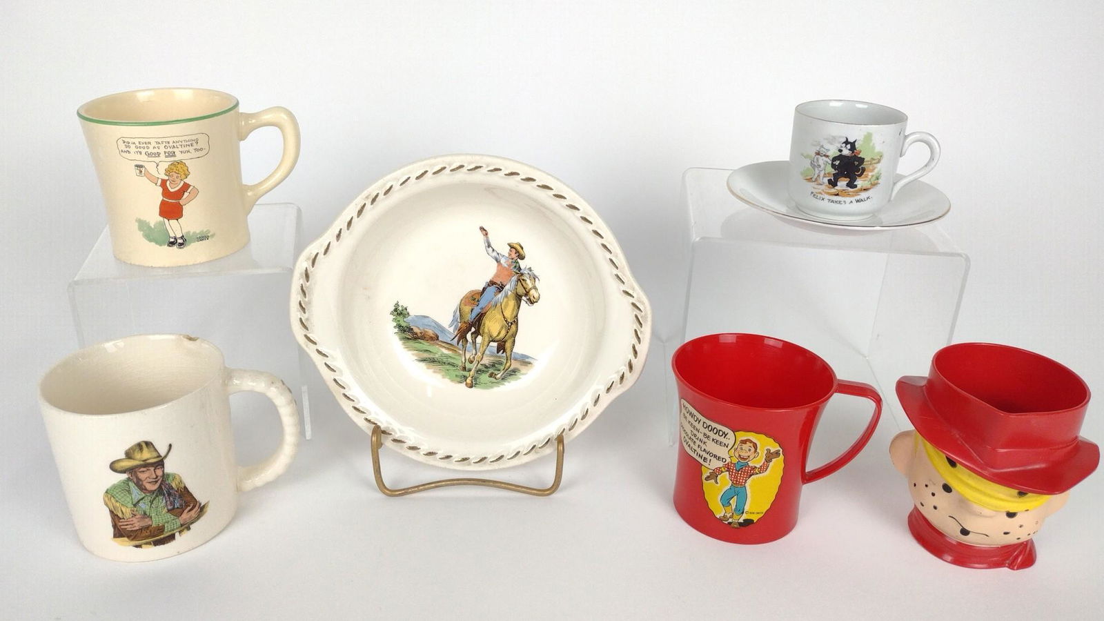 7 Child's Character Dishes incl Annie: Also includes Felix the Cat, Howdy Doody, and more. 2" to 3-1/2" high. One mug with chip to rim. DM IMPORTANT: Before bidding, please read the terms and conditions. When you registered for the auction