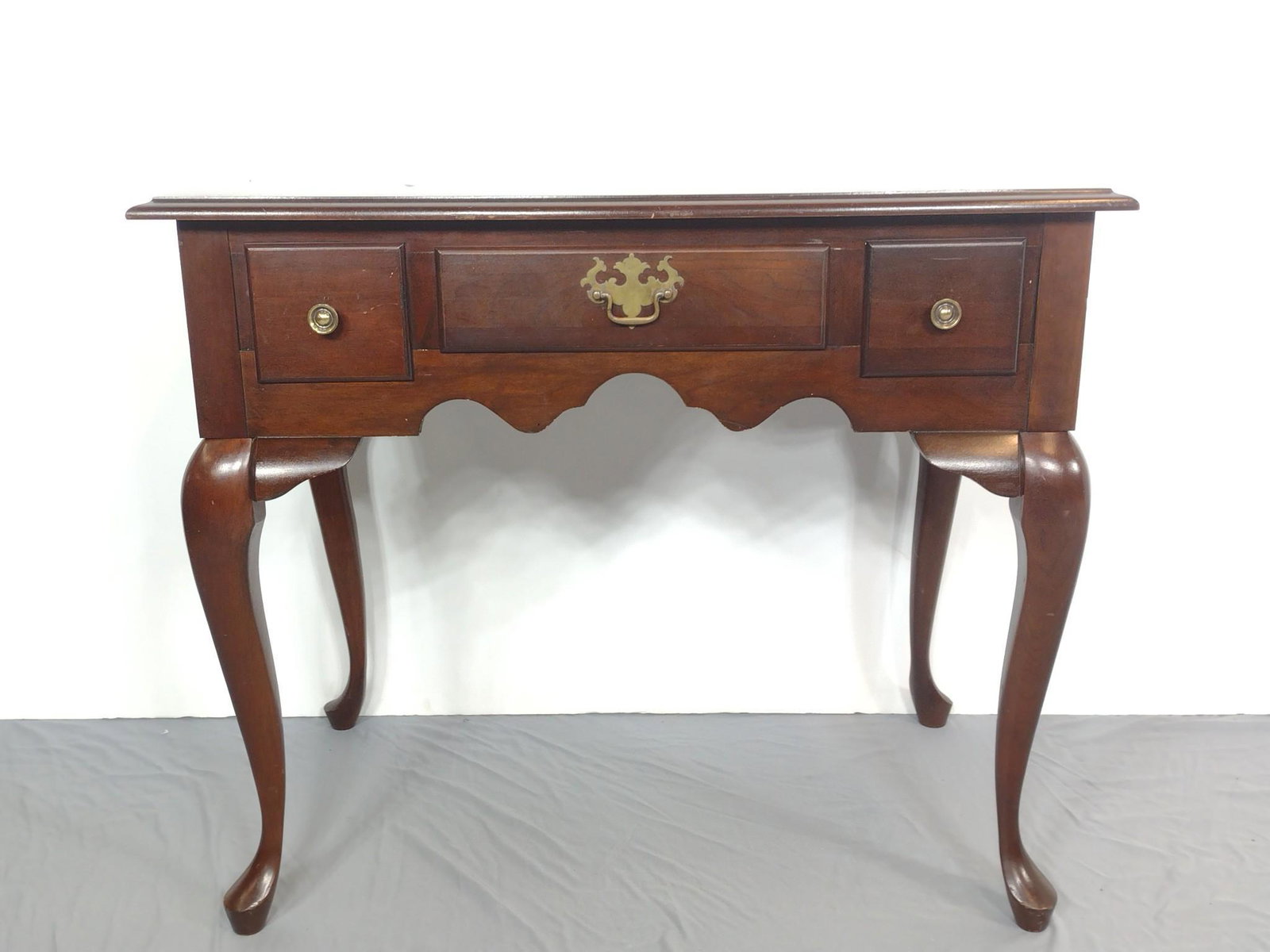 Queen Anne Style Low Boy: 34-1/2" wide X 20" deep X 29-1/2" high. Top has scratches. MG. IMPORTANT: Before bidding, please read the terms and conditions. When you registered for the auction you agreed to these terms and will b