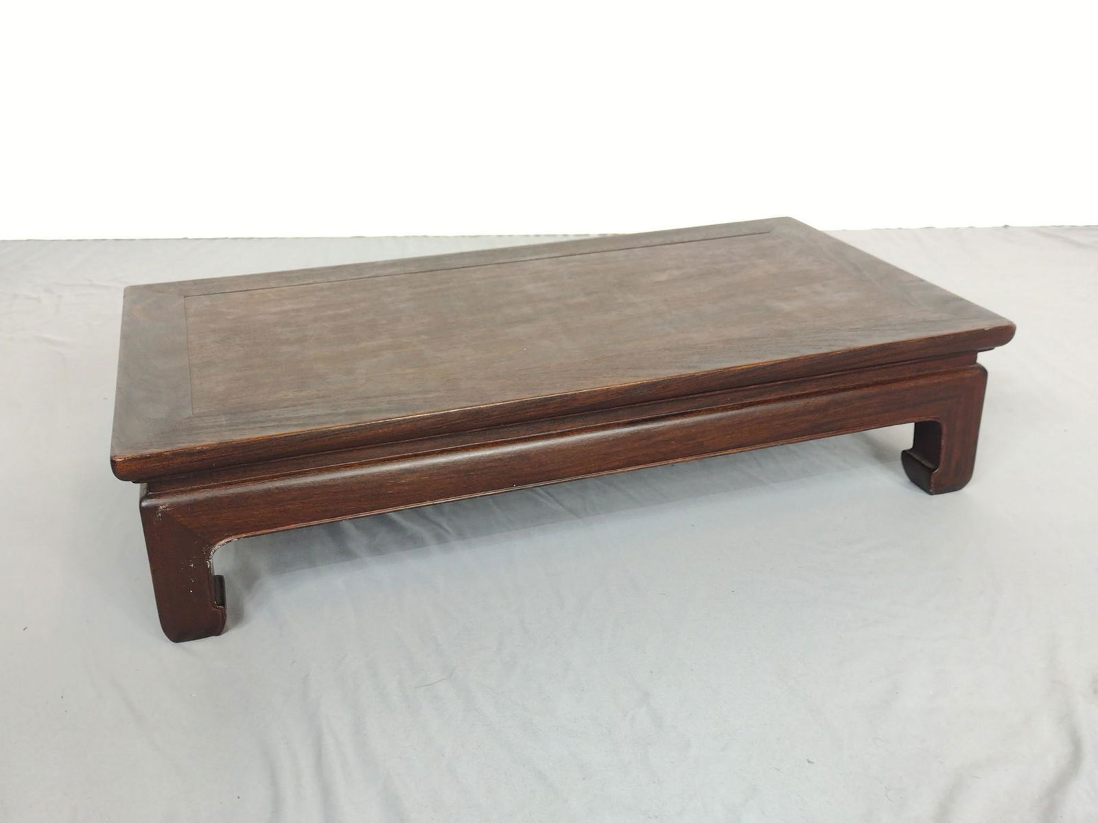 Low Asian Stand: 25-1/2" wide X 13-1/2" deep X 6" high. Has some light discoloring to top. MG IMPORTANT: Before bidding, please read the terms and conditions. When you registered for the auction you agreed to these te