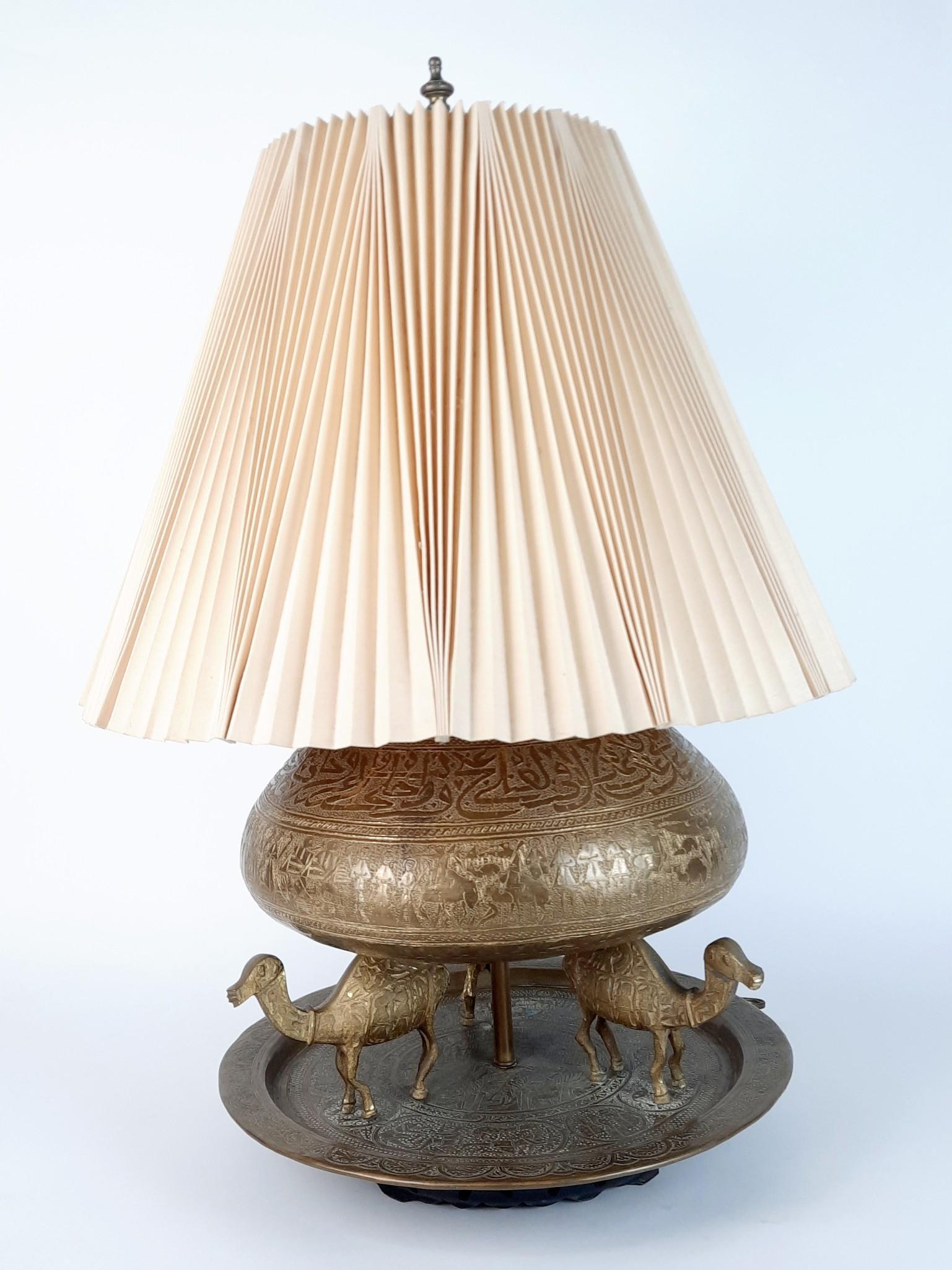 Figural Brass Lamp with Camels Mounted on Tray: Working. 19" diameter x 27" high. LR IMPORTANT: Before bidding, please read the terms and conditions. When you registered for the auction you agreed to these terms and will be required to comply with 