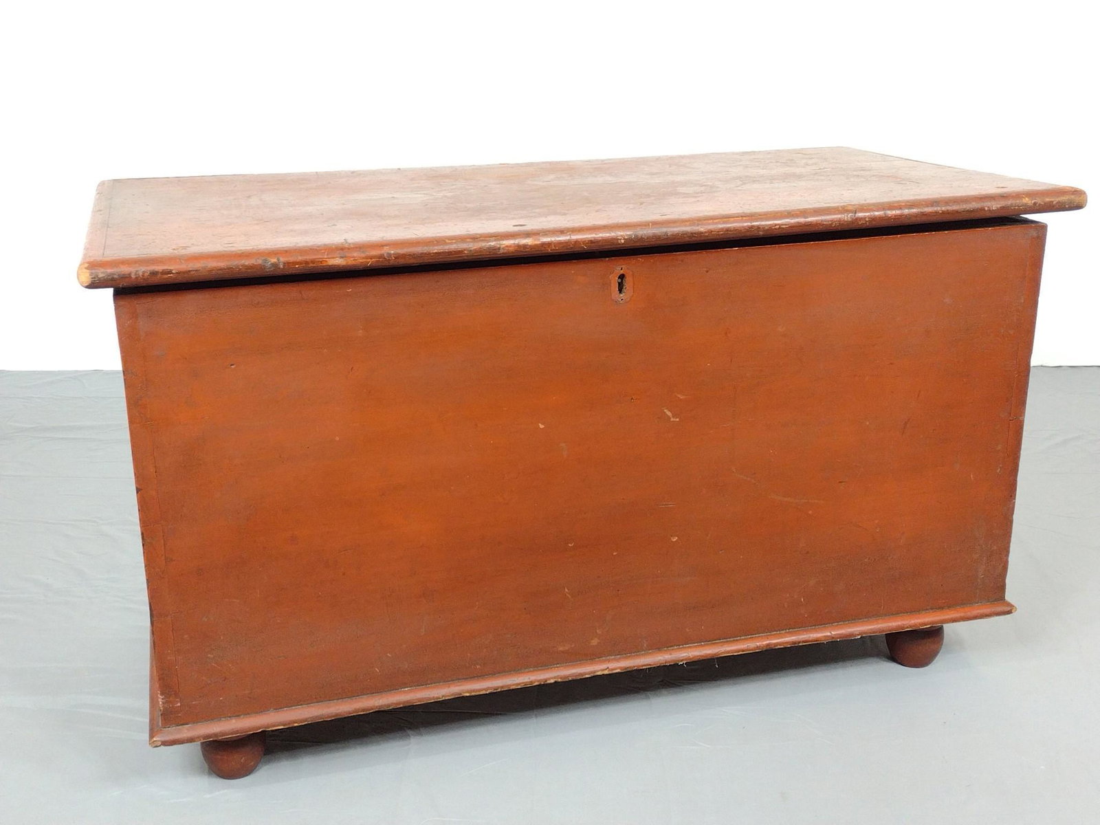 Red Painted Blanket Chest: 38" wide X 19" deep X 22" high. Has some scratches and paint loss. Locking mechanism in locked position. No key. Top opens and closes freely, but does not fully close. MG. IMPORTANT: Before bidding, p