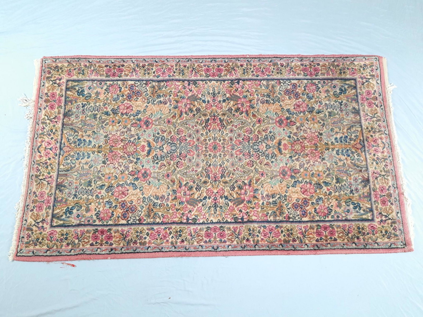 Vintage Floral Area Rug: 3' x 5'. Some fading and losses / pulls in fringe. LR IMPORTANT: Before bidding, please read the terms and conditions. When you registered for the auction you agreed to these terms and will be require