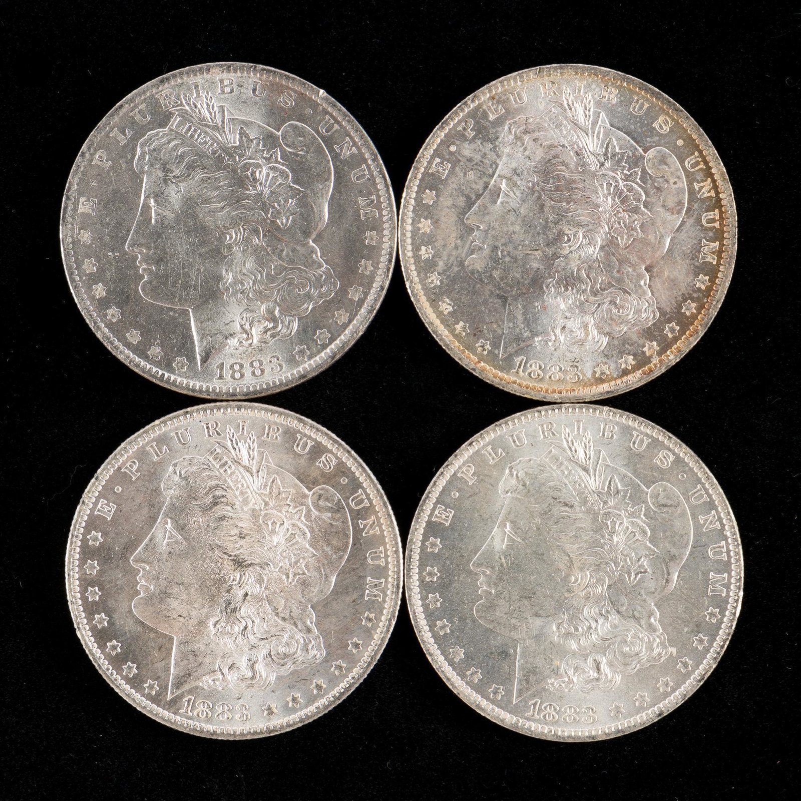 4 1883-O Morgan Silver Dollars: Choice brilliant. RM IMPORTANT: Before bidding, please read the terms and conditions. When you registered for the auction you agreed to these terms and will be required to comply with them.