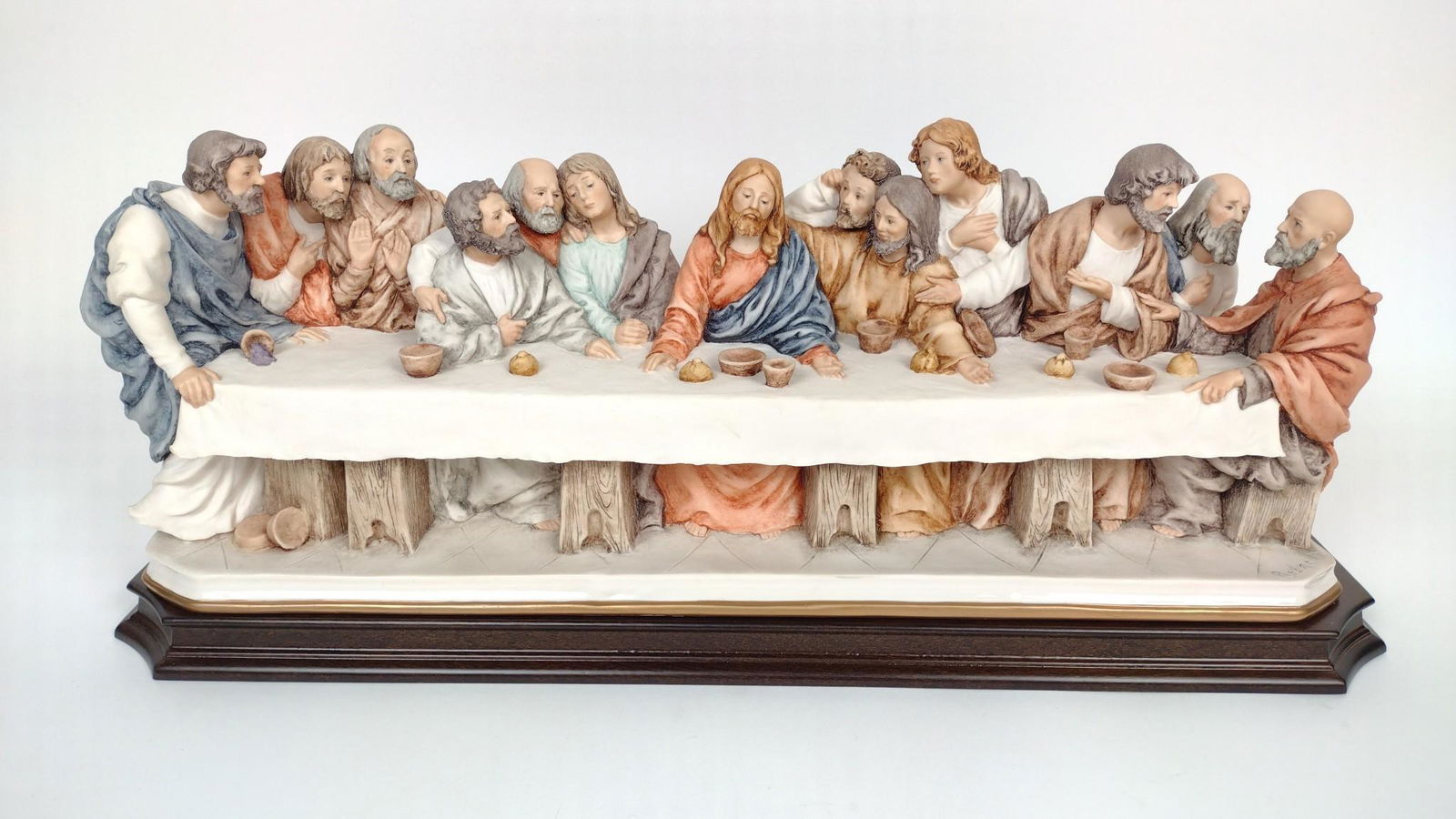 Giuseppe Armani 'The Last Supper' Sculpture: 23-1/2" wide X 6-1/2" deep X 9" high. Signed "Redaelli." With original box. DM IMPORTANT: Before bidding, please read the terms and conditions. When you registered for the auction you agreed to these