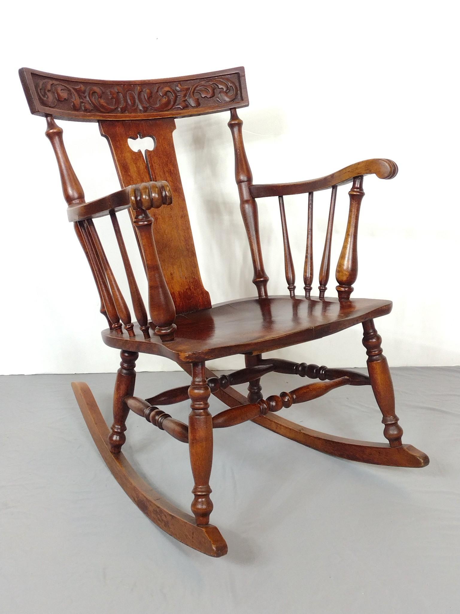 Carved Rocking Chair: 22" wide X 31-1/2" deep X 33-1/2" high. Plank bottom has repair. MG. IMPORTANT: Before bidding, please read the terms and conditions. When you registered for the auction you agreed to these terms and 