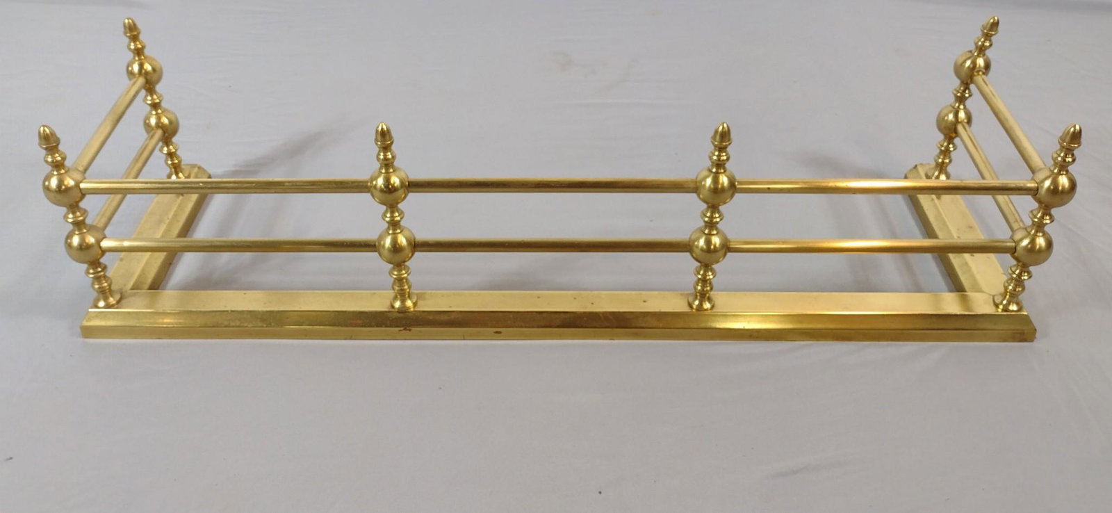 Brass Fire Fender: 42" wide x 12" deep x 11" high. Some surface wear and oxidation. LR / DM IMPORTANT: Before bidding, please read the terms and conditions. When you registered for the auction you agreed to these terms 