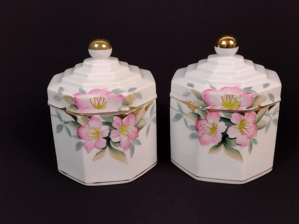 2 Noritake Azalea Tobacco Jars: Both with red backstamp dates 1920s manufacturing. Each 4" wide x 4" deep x 5-1/2" high. LR IMPORTANT: Before bidding, please read the terms and conditions. When you registered for the auction you agr