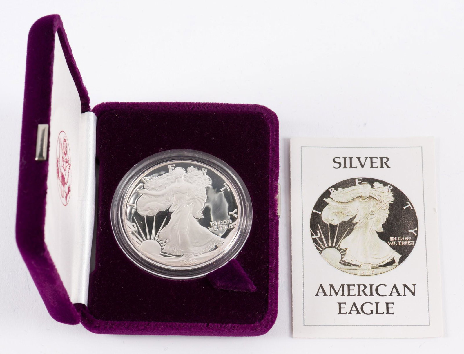 1986 American Silver Eagle: Includes box and certificate of authenticity. Proof. KE. IMPORTANT: Before bidding, please read the terms and conditions. When you registered for the auction you agreed to these terms and will be requ