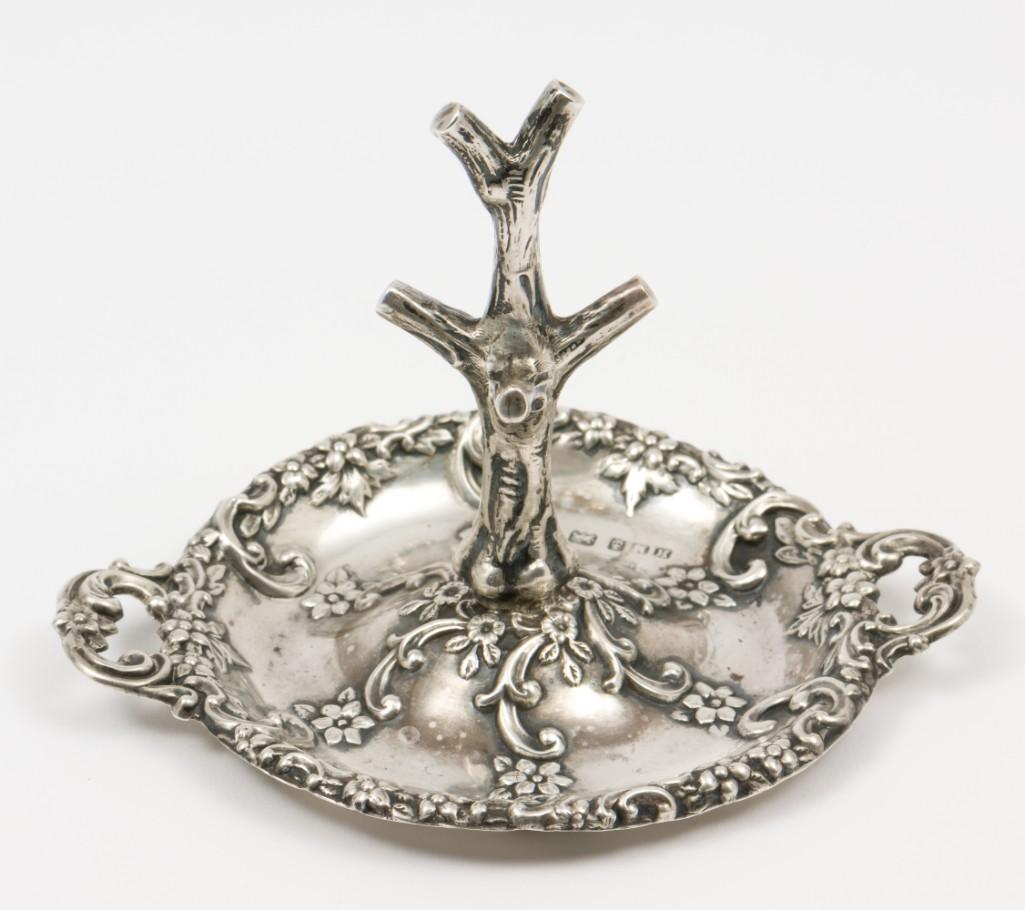 Henry Matthews Birmingham Sterling Ring Holder: Hallmarked for Henry Matthew, Birmingham. Date marked 1901. 4-1/4" wide x 3-1/8" high. 1.0 ozt. RM IMPORTANT: Before bidding, please read the terms and conditions. When you registered for the auction