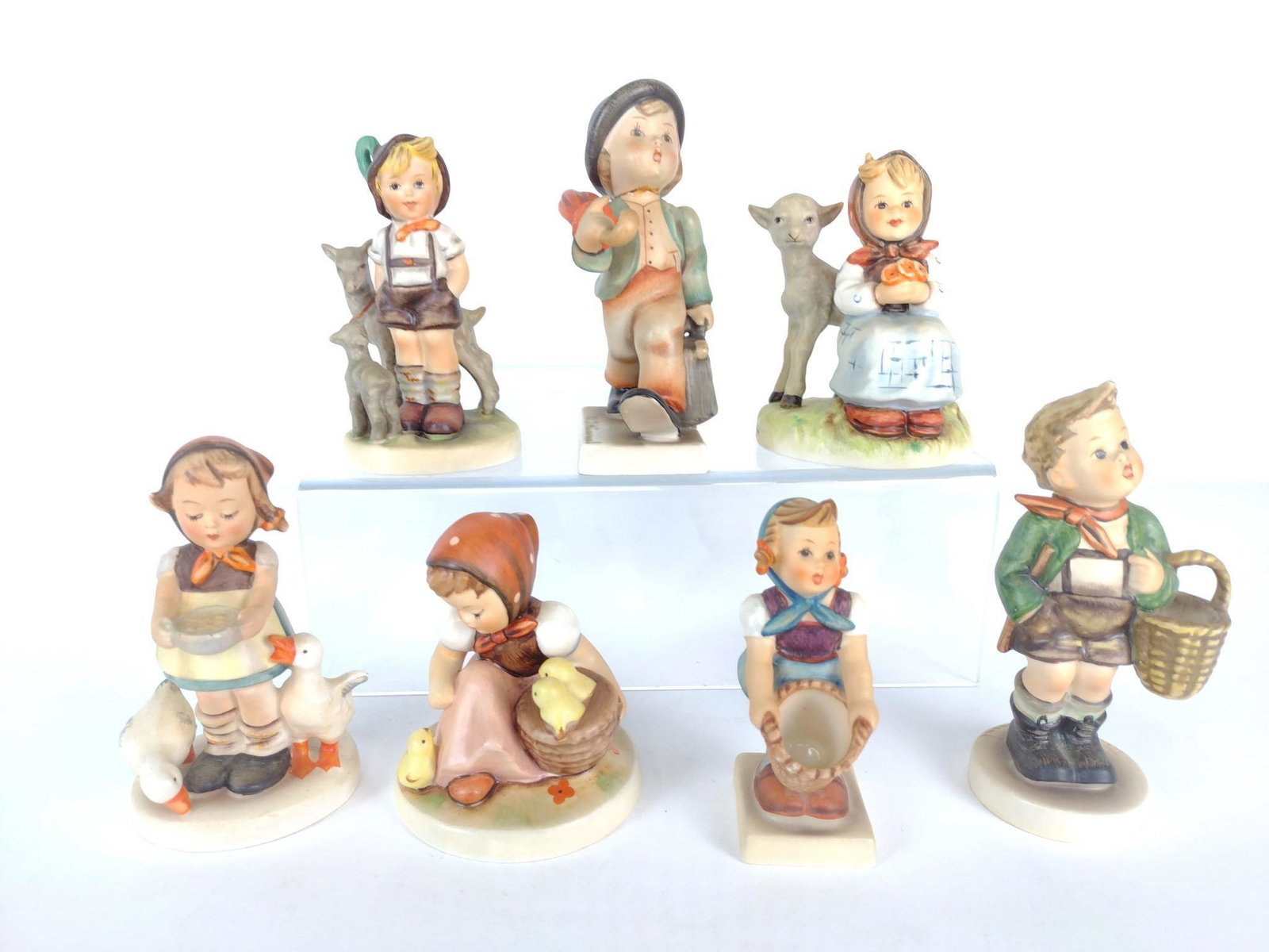 7 Hummel Figurines: All marked to bottom. 3-1/2" to 4-3/4" high x 1-3/4" to 3" wide. KE. IMPORTANT: Before bidding, please read the terms and conditions. When you registered for the auction you agreed to these terms and 