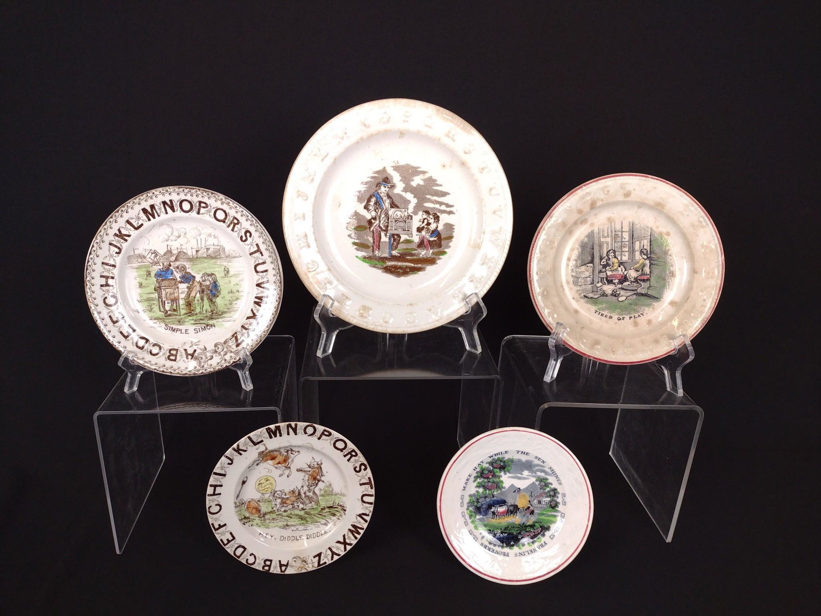 5 Child's Plates Incl Make Hay While the Sun Shines: One plate illegibly marked to back. 5-1/2" to 8-1/4" diameter. Stains to plates. KE. IMPORTANT: Before bidding, please read the terms and conditions. When you registered for the auction you agreed to 