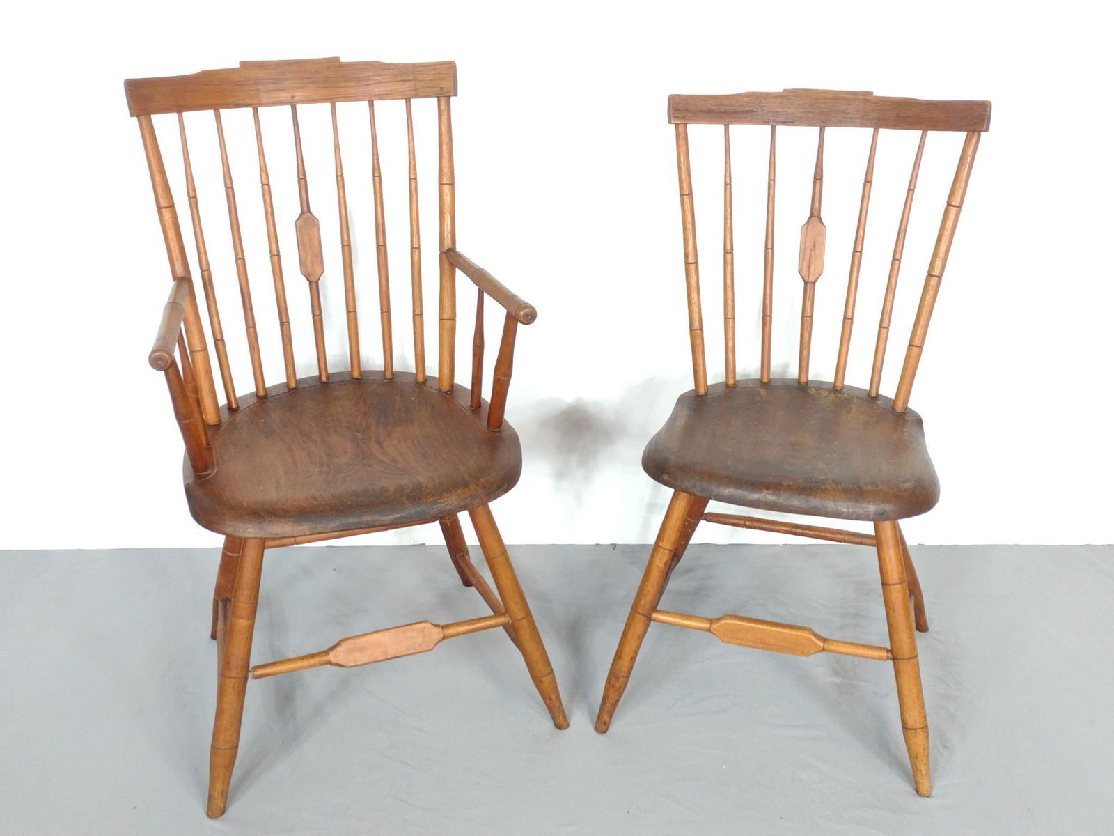 Pair Of Windsor Chairs: 18" wide X 17" deep X 35-1/2" high. MG. IMPORTANT: Before bidding, please read the terms and conditions. When you registered for the auction you agreed to these terms and will be required to comply wi