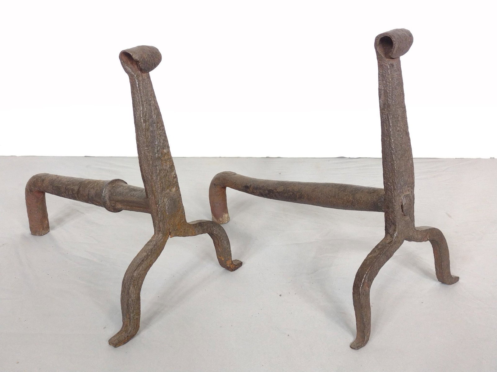 Wrought Iron Andirons: 10" wide X 17" deep X 15-1/2" high. MG. IMPORTANT: Before bidding, please read the terms and conditions. When you registered for the auction you agreed to these terms and will be required to comply wi