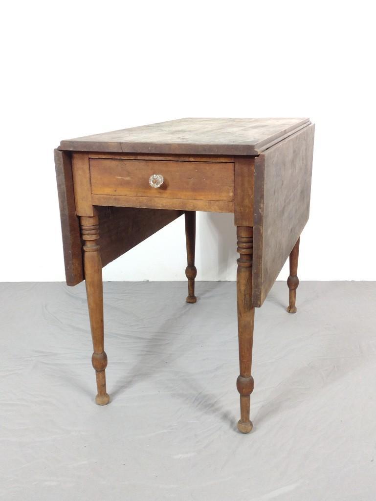 Drop Side Table: Open 46", closed 20-1/4" wide X 36" deep X 29" high. Has scratches and discoloring. MG. IMPORTANT: Before bidding, please read the terms and conditions. When you registered for the auction you agreed 