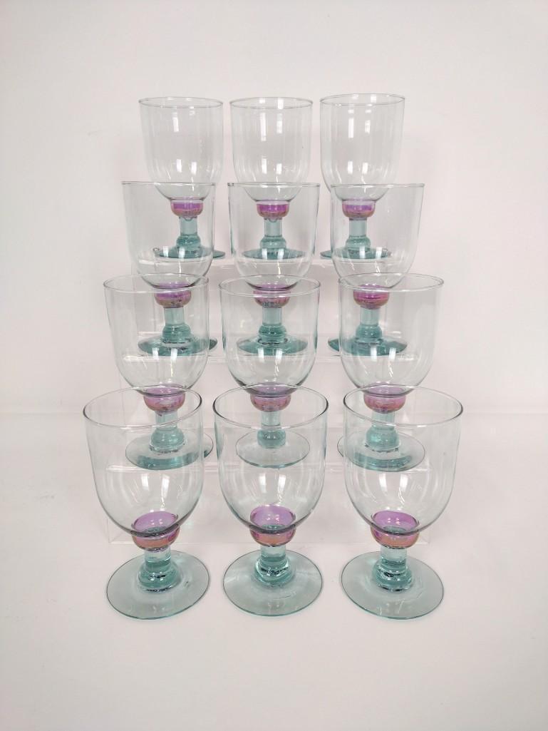 12 Blue/Purple Goblets: Unmarked. 6-1/2" high x 3-1/2" diameter. Some with chips to bases. RM IMPORTANT: Before bidding, please read the terms and conditions. When you registered for the auction you agreed to these terms and