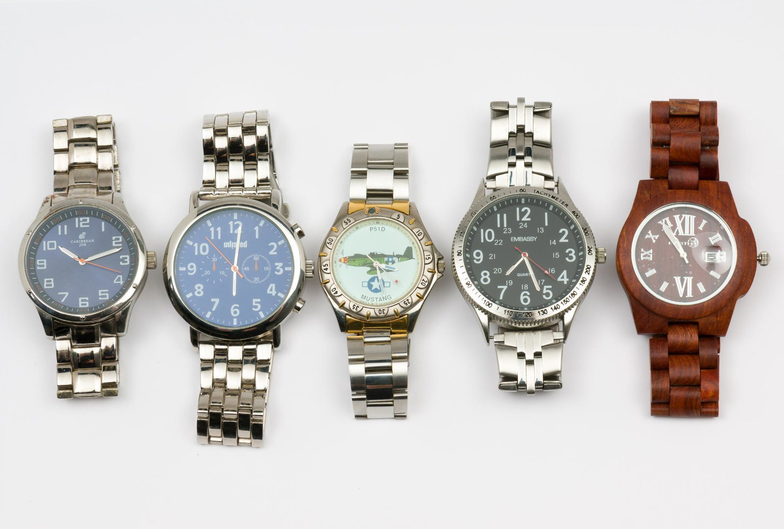 5 Men's Wristwaches: Embassy GEN4039 with stainless steel band and Singapore movement, 2" interior diameter, 2-1/8" lug to lug. Caribbean Joe with stainless steel band and Japan movement, 2-1/4" interior diameter, 2" lug 