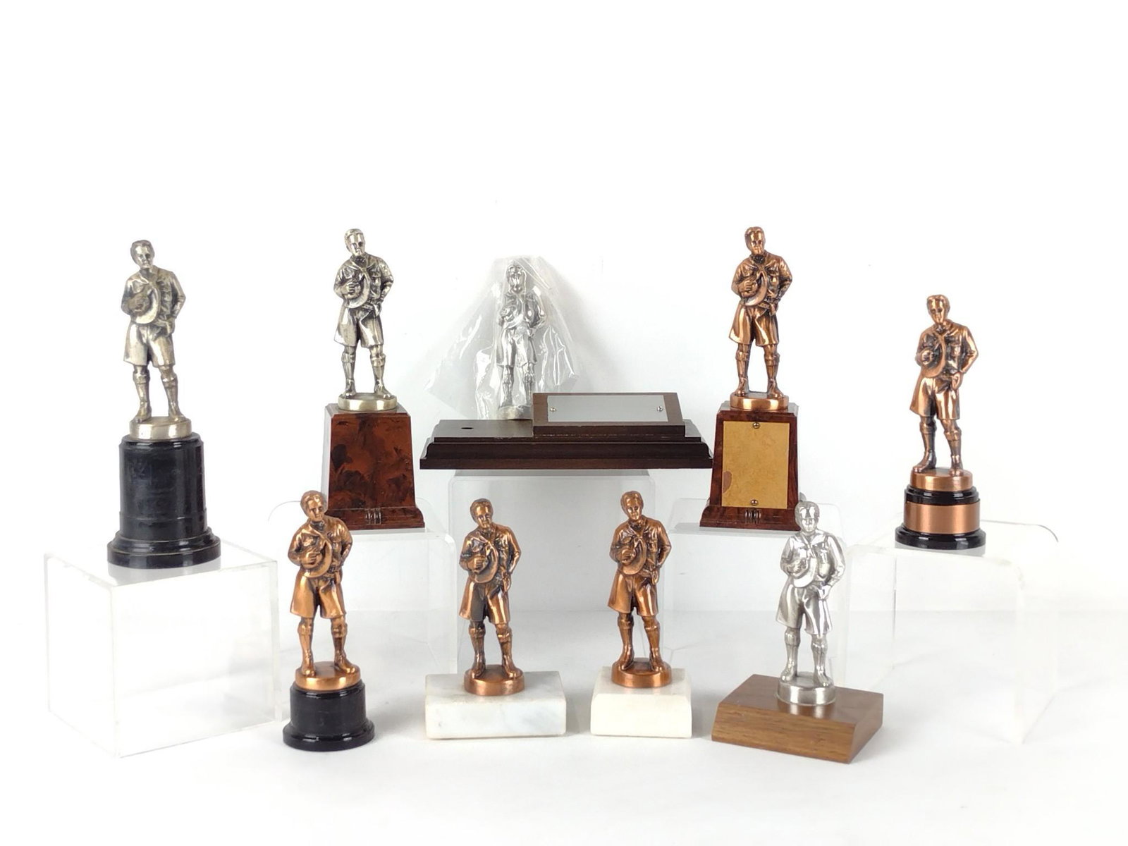 9 Vintage Boy Scout Trophies: 5-1/4" to 7" high x 2" to 7-1/4" wide. One with chip to front. DP. IMPORTANT: Before bidding, please read the terms and conditions. When you registered for the auction you agreed to these terms and wi