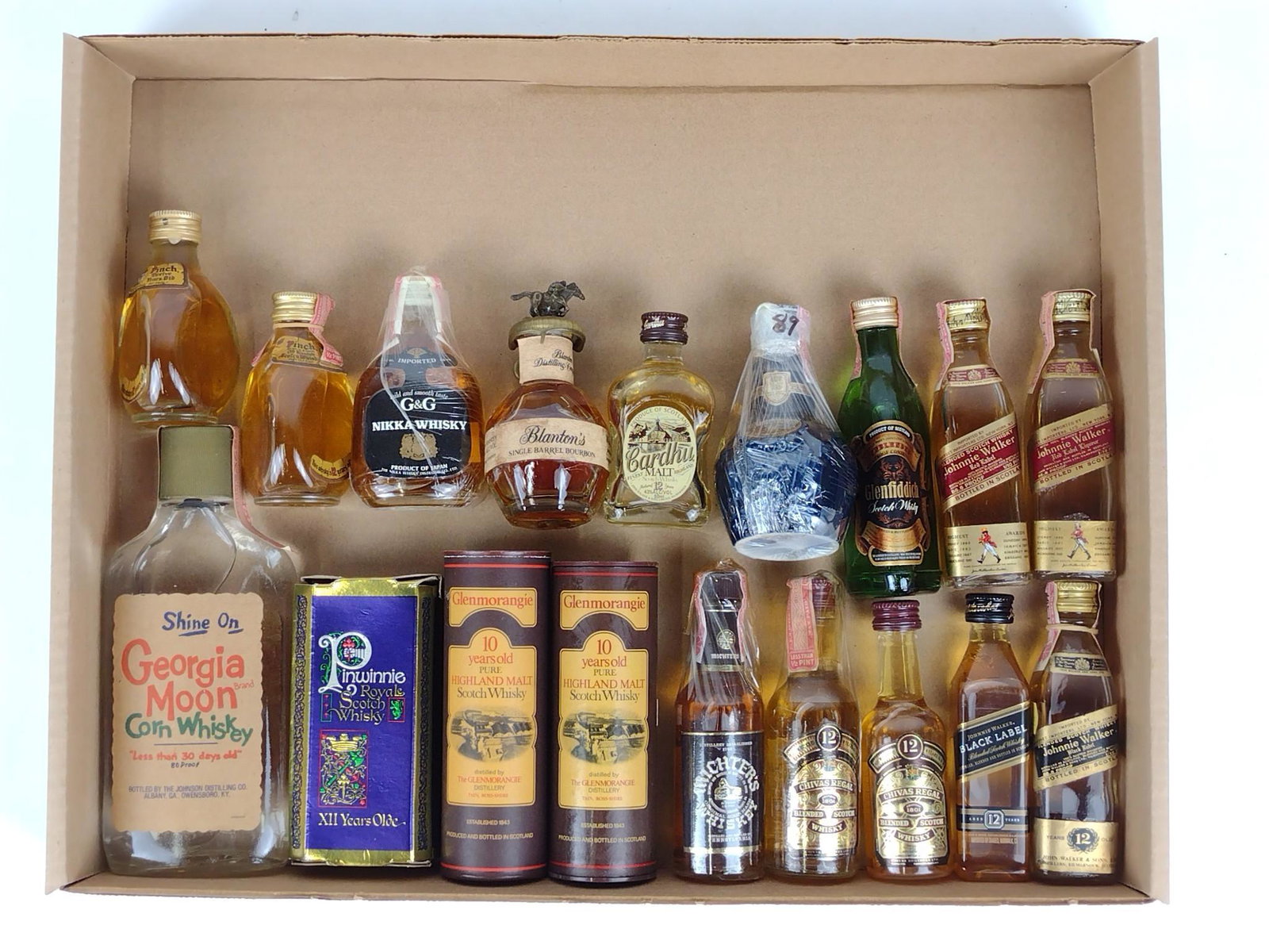 18 Miniature Bottles Estate Whisky Incl Blanton's: Also includes Pinch 12, Johnnie Walker, Chivas Regal, Glenmorangie, etc. All sealed and unopened. DP. This lot cannot be shipped. IMPORTANT: Before bidding, please read the terms and conditions. When 