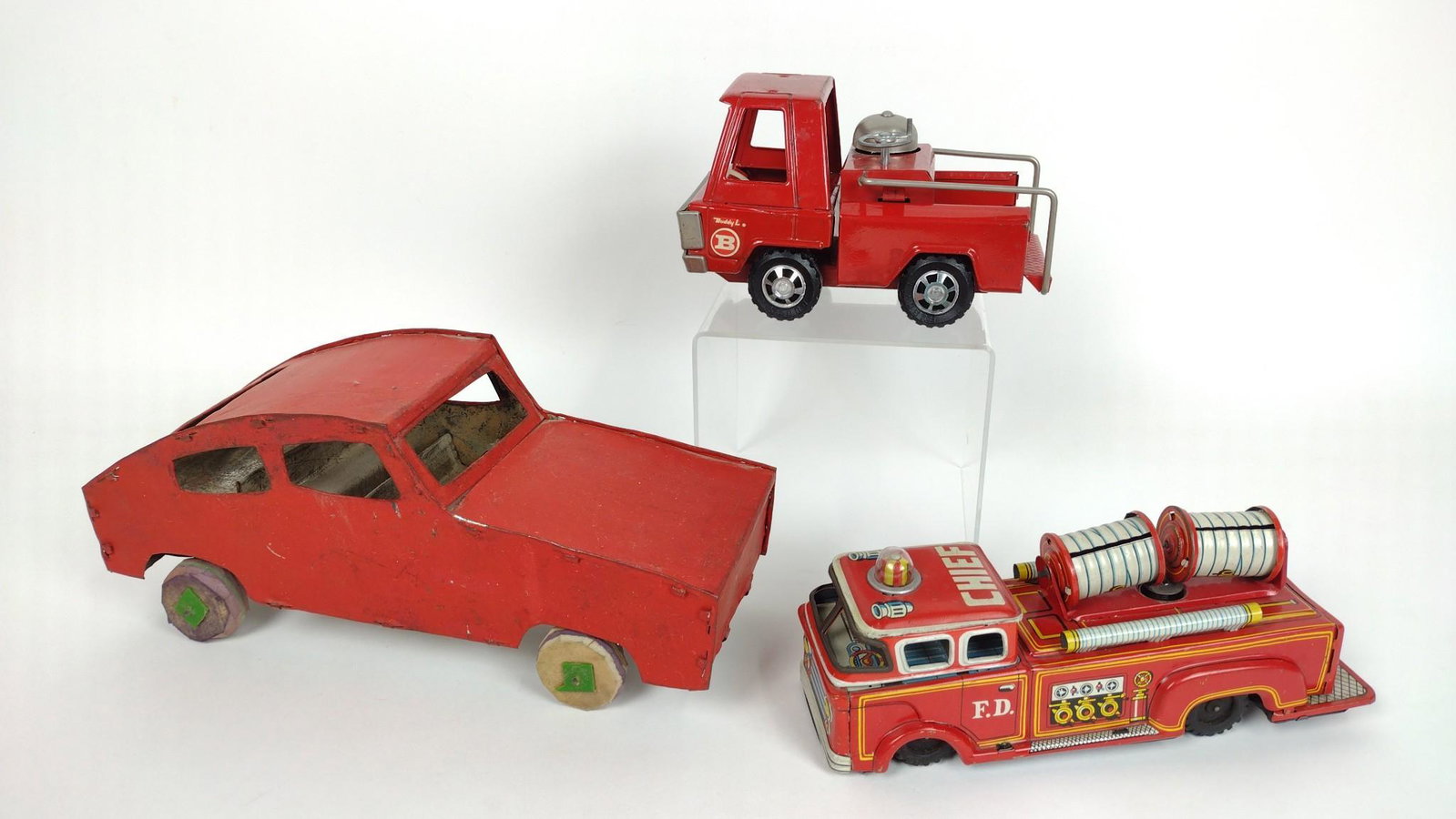 3 Vintage Tin Cars incl Firetruck: Includes Made in Japan and Buddy L. 6-3/4" to 11-1/2" long X 3" to 5" high. DM IMPORTANT: Before bidding, please read the terms and conditions. When you registered for the auction you agreed to these 