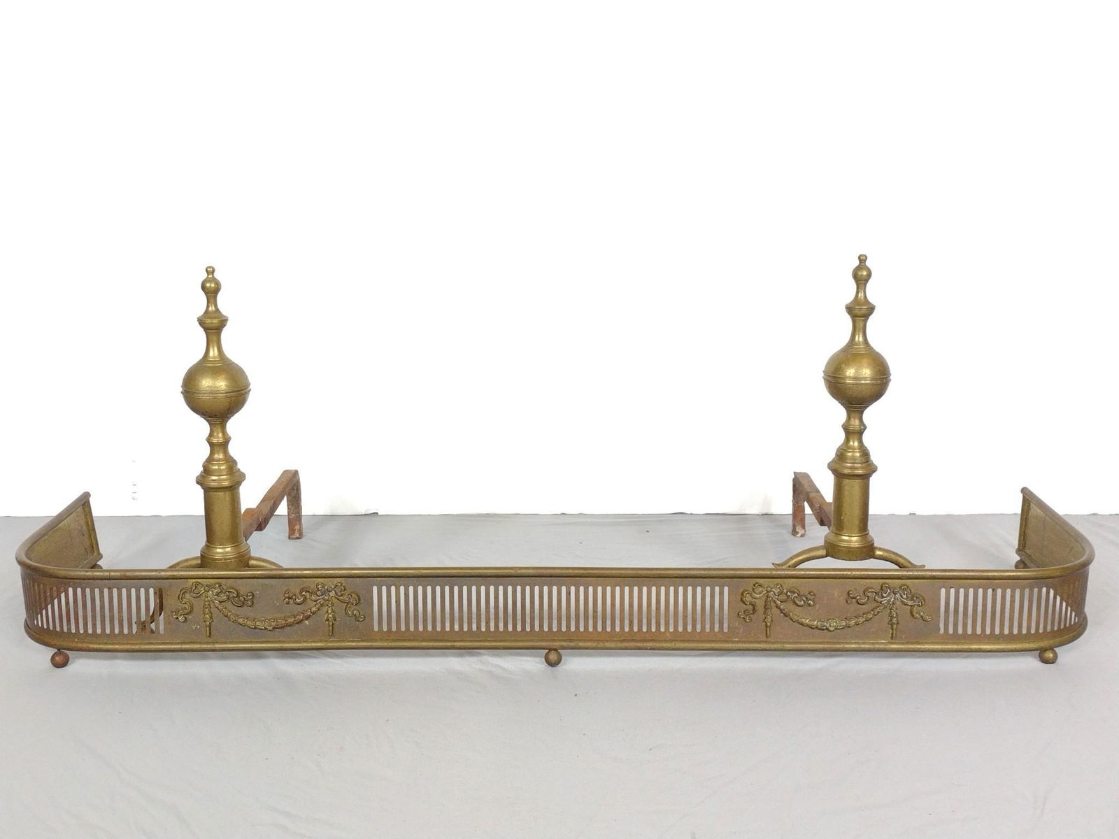 Brass Andirons and Fire Fender: Andirons 9-1/2" wide X 18-1/2" deep X 19" high. 55" wide X 15" deep X 4-3/4" high. Some oxidation and rust. MG. IMPORTANT: Before bidding, please read the terms and conditions. When you registered for