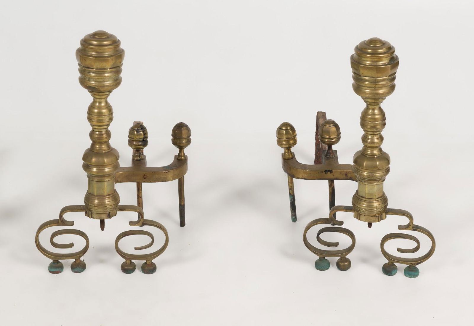 Pair Brass Beehive Andirons: Pair of brass beehive andirons with curled front legs and ball feet. Two finials on a S curve leading to billet bar. Unmarked. 21" high x 23-1/2" deep x 11-1/8". Crack to brass at base of front end an