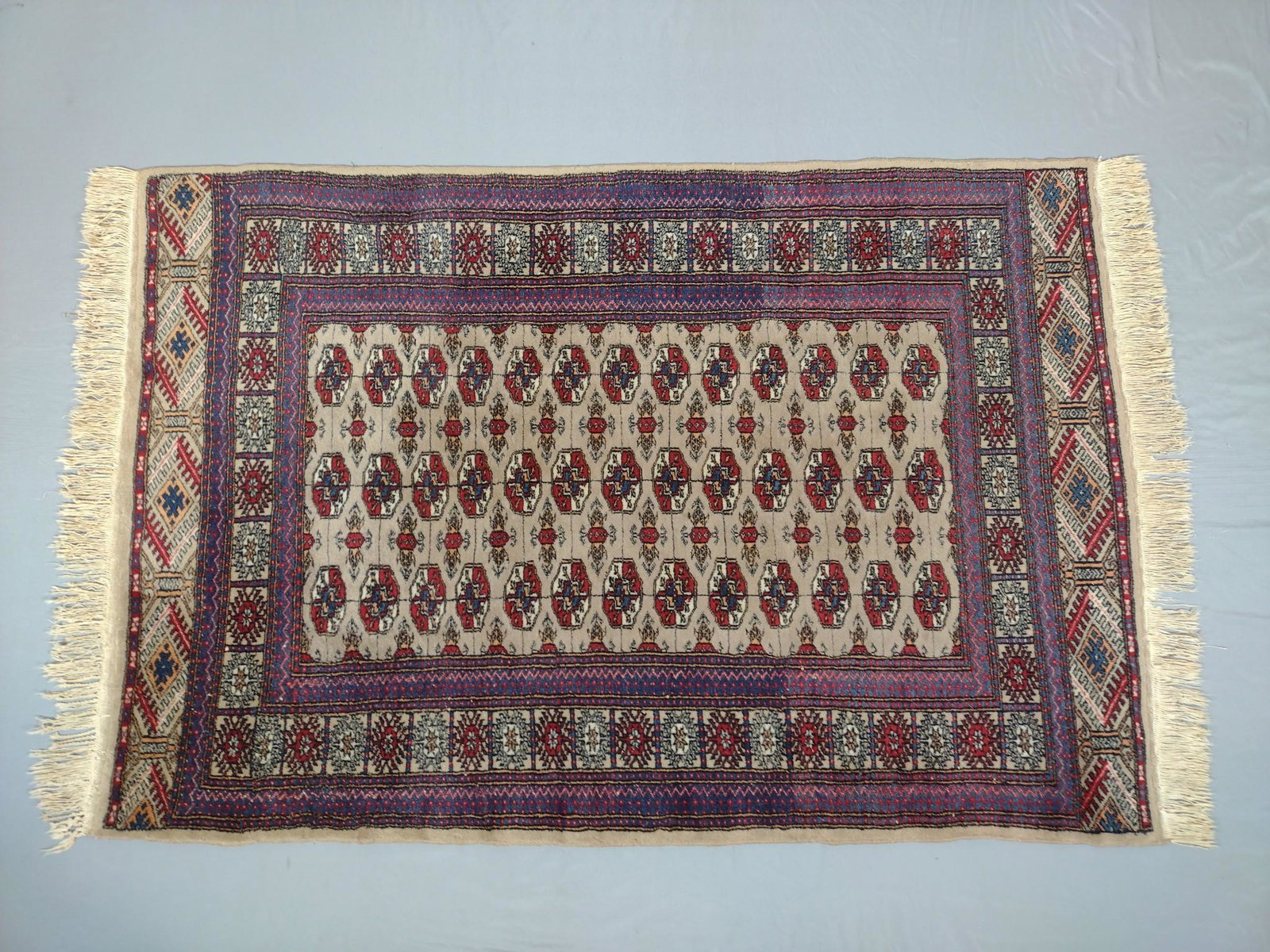 Persian Area Rug: Circa 1980s. 56" long X 38-1/2" wide. MG. IMPORTANT: Before bidding, please read the terms and conditions. When you registered for the auction you agreed to these terms and will be required to comply 