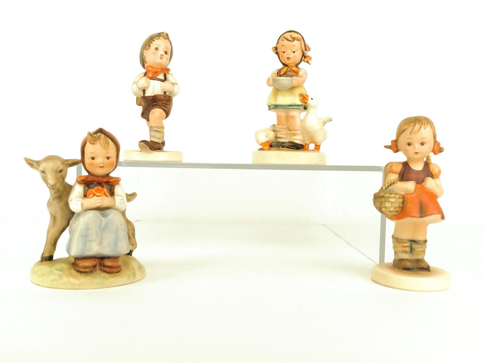 4 Hummel Figurines: 2" to 3-1/2" wide x 4-1/4" to 5" high. KE. IMPORTANT: Before bidding, please read the terms and conditions. When you registered for the auction you agreed to these terms and will be required to comply